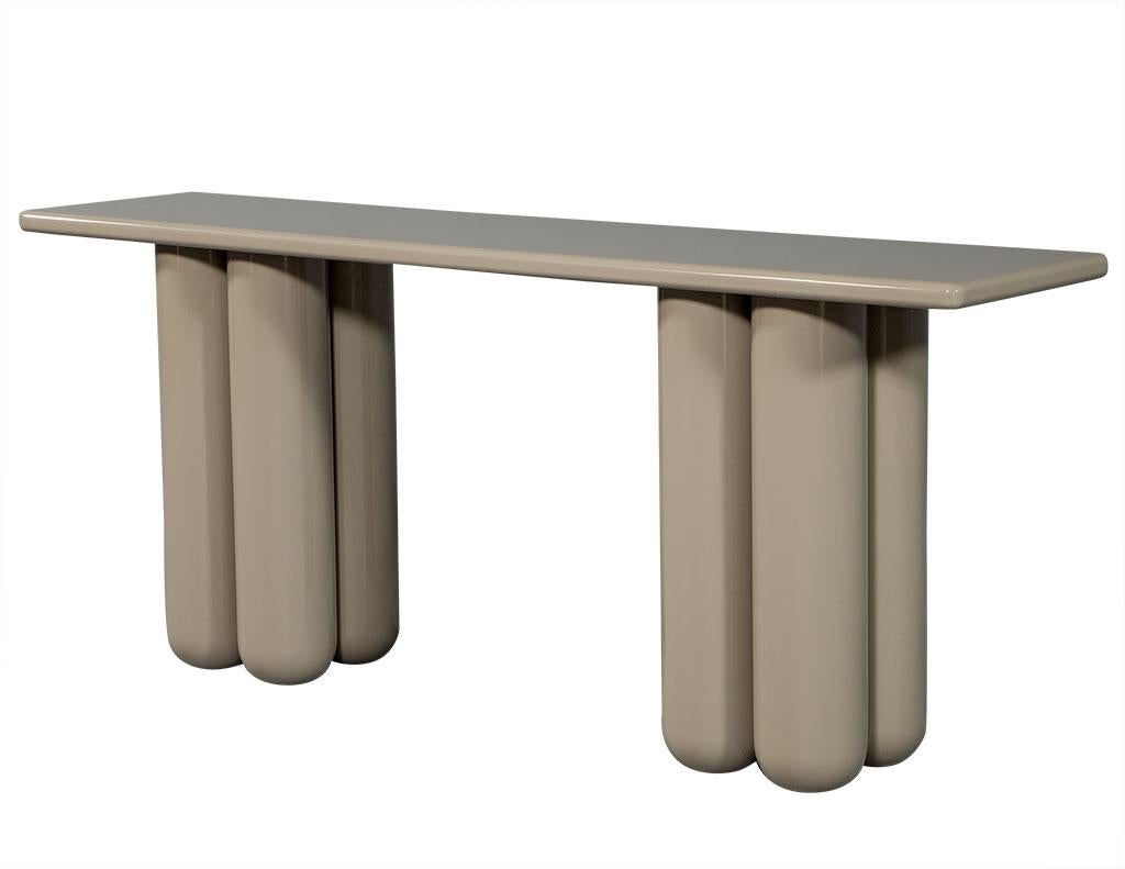 Modern tube design console table. Unique cylinder bases on solid rounded top. Finished in a hand polished cappuccino color.
Price includes complimentary curb side delivery to the continental USA.