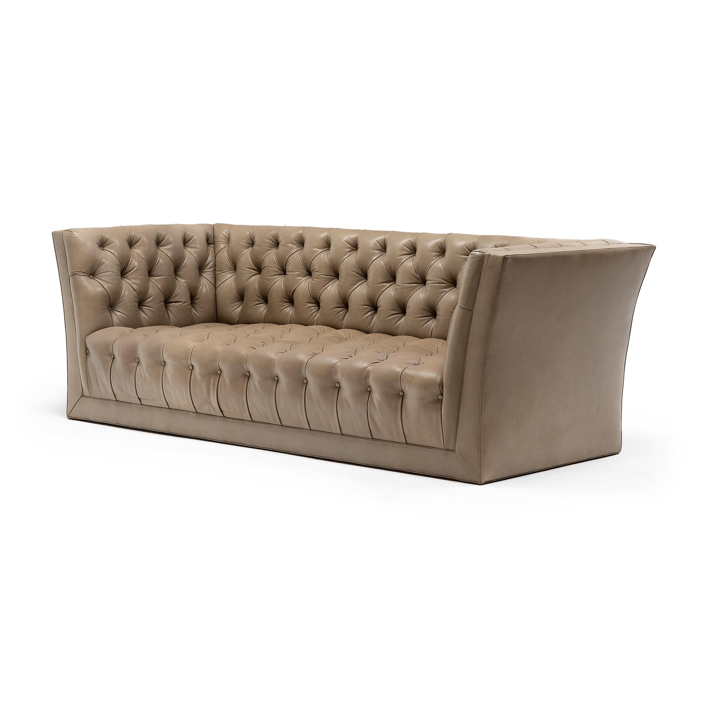 This statement leather sofa reinvents MCM designs with fine materials and a neutral palette. The low sofa is upholstered in a lush Napa leather with pale taupe color and a wonderfully soft texture. Crafted in the style of mid-century modern, the