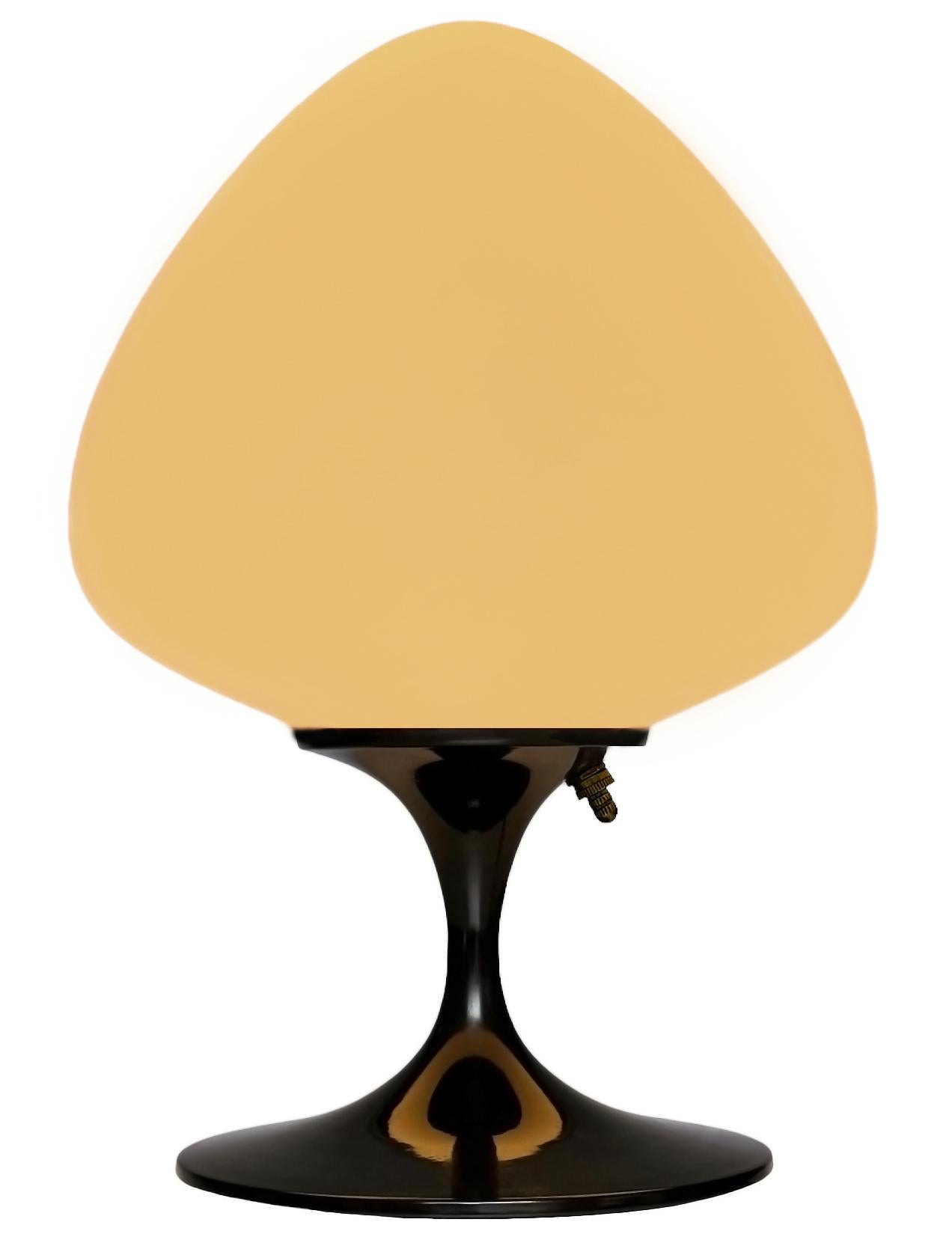 A gorgeous tulip form table lamp, desk lamp or bedside lamp. It features a glossy black cast aluminum base with mouth blown frosted white glass shade in an acorn form. It takes one standard bulb up to 100 watts.

These retro lamps work with all