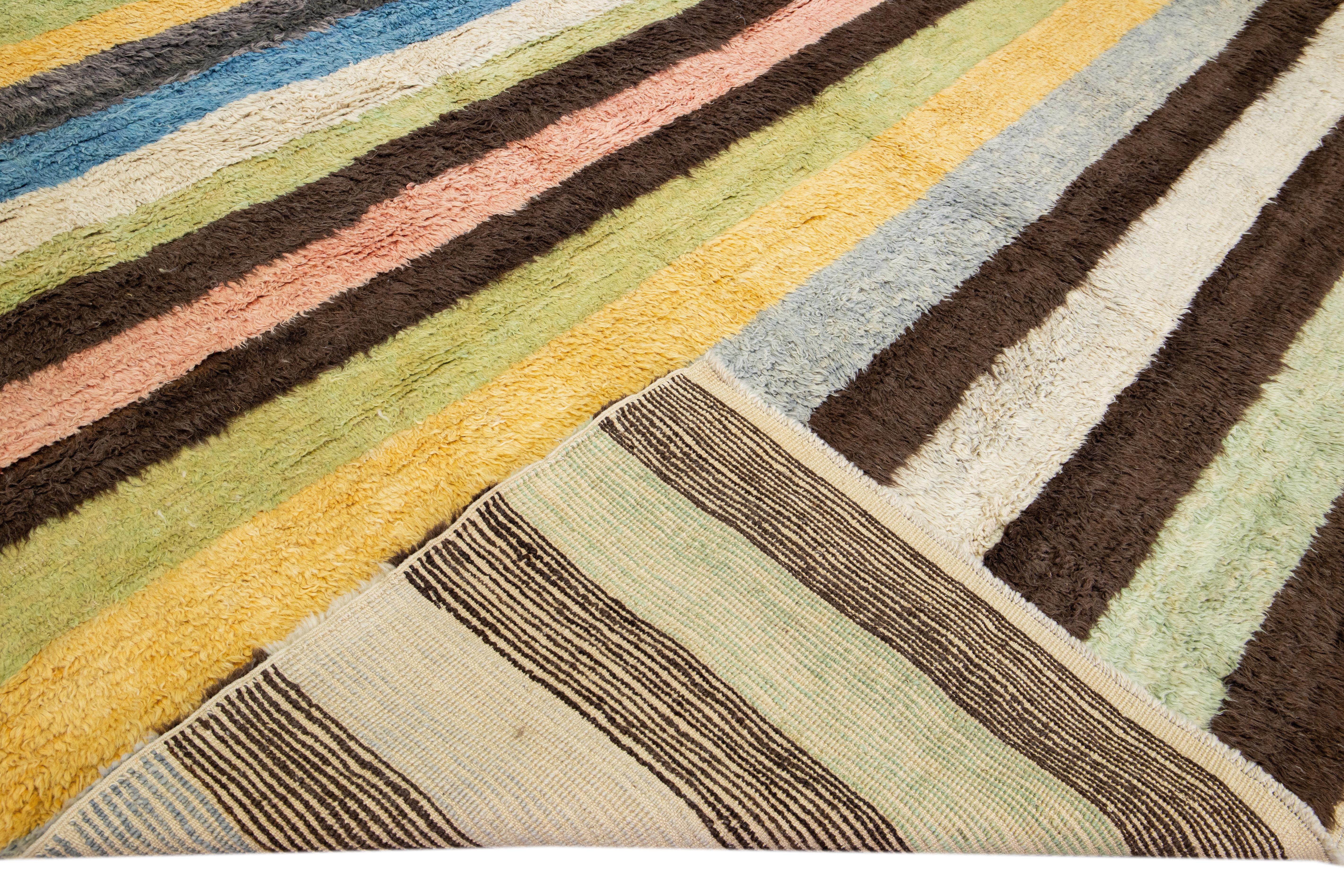 Beautiful modern Tulu hand-knotted wool rug with a multicolor field. This Tulu rug has a gorgeous all-over striped design. 

This rug measures: 12'6