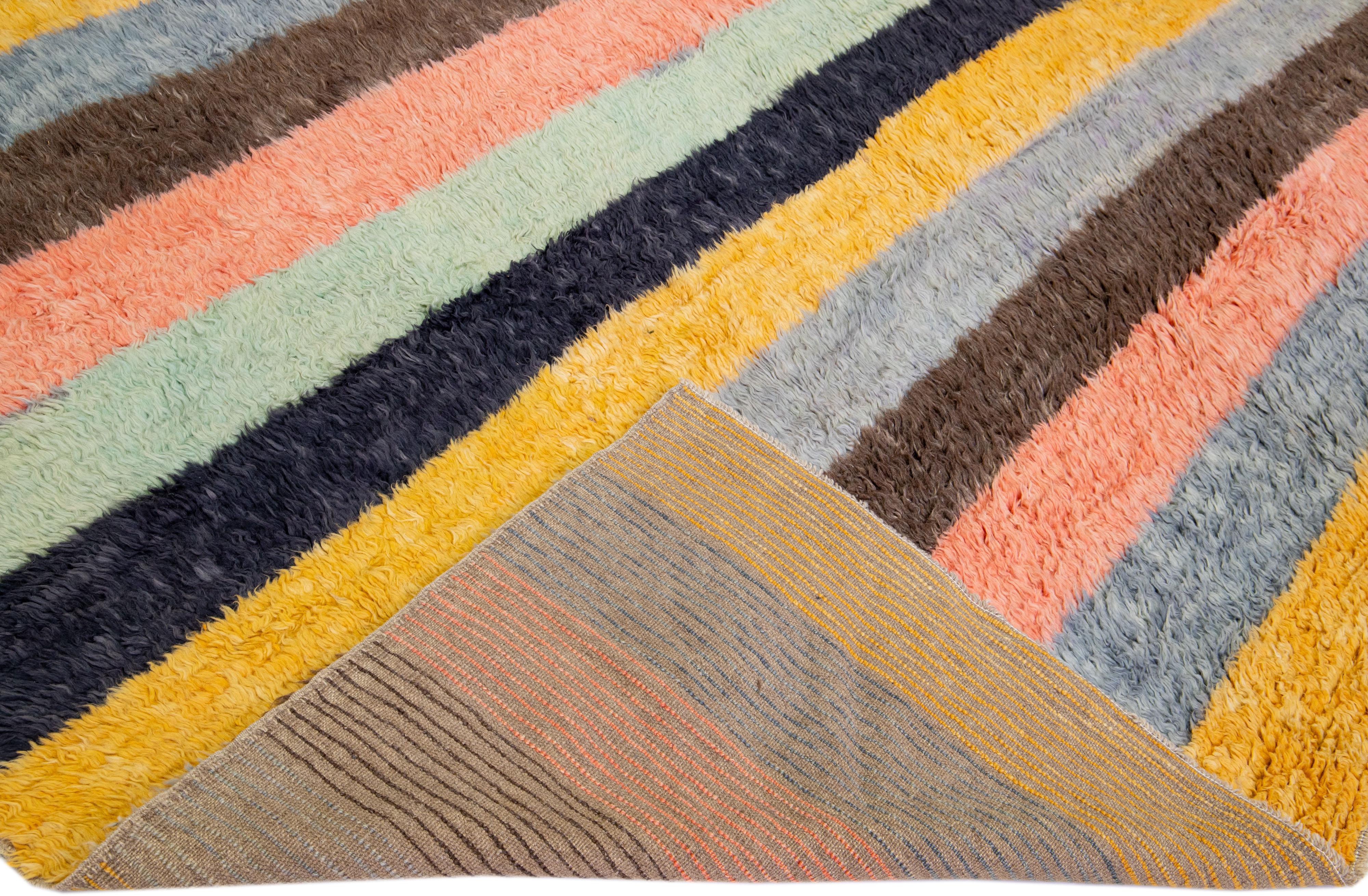 Beautiful modern Tulu hand-knotted wool rug with a multicolor field. This Tulu rug has a gorgeous all-over striped design. 

This rug measures: 12'3
