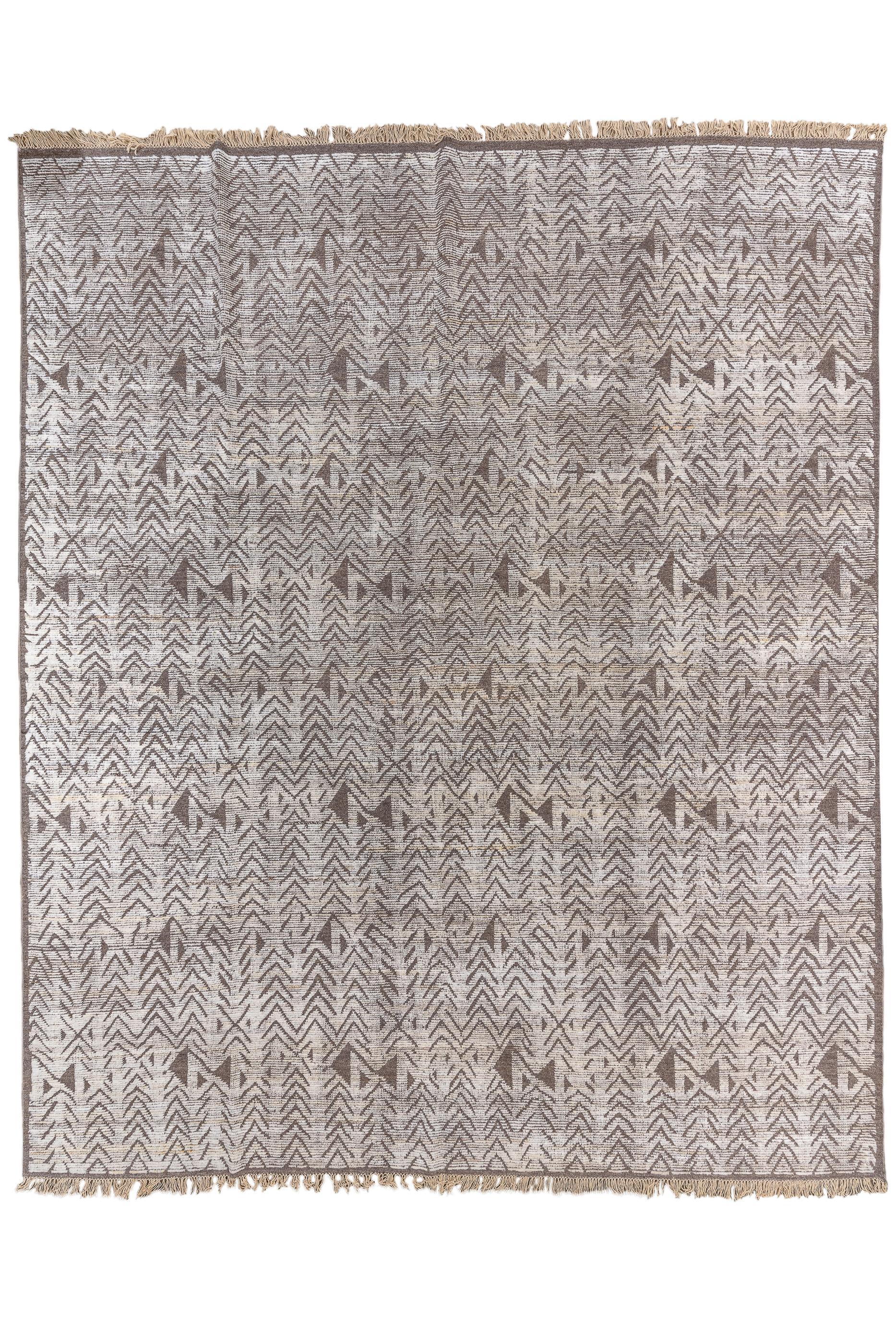 An exceptionally large Tulu with a richly abrashed pearl ecru ground presenting slender columns of floating herringbone chevrons, periodically interrupted by geometric dark brown lazy S’s. Very narrow plain dark brown frame. Coarse, recumbent weave.
