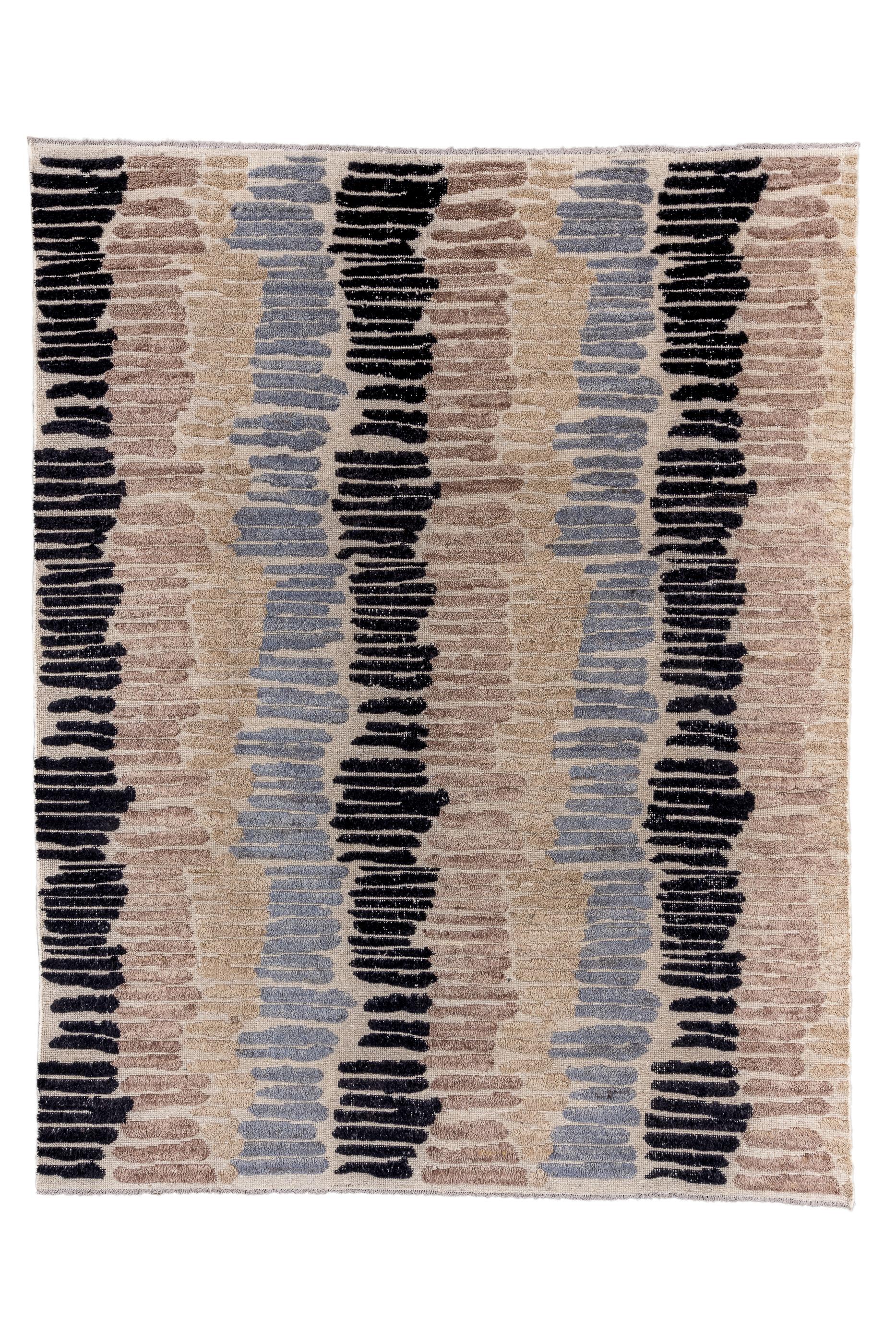This unusual Anatolian rustic, long pile carpet, shows a columnar, brushstroke pattern in shades of charcoal, light blue and teal, on the well-covered ecru ground. The brushstroke horizontals repeat three times vertically, but the pattern is in no