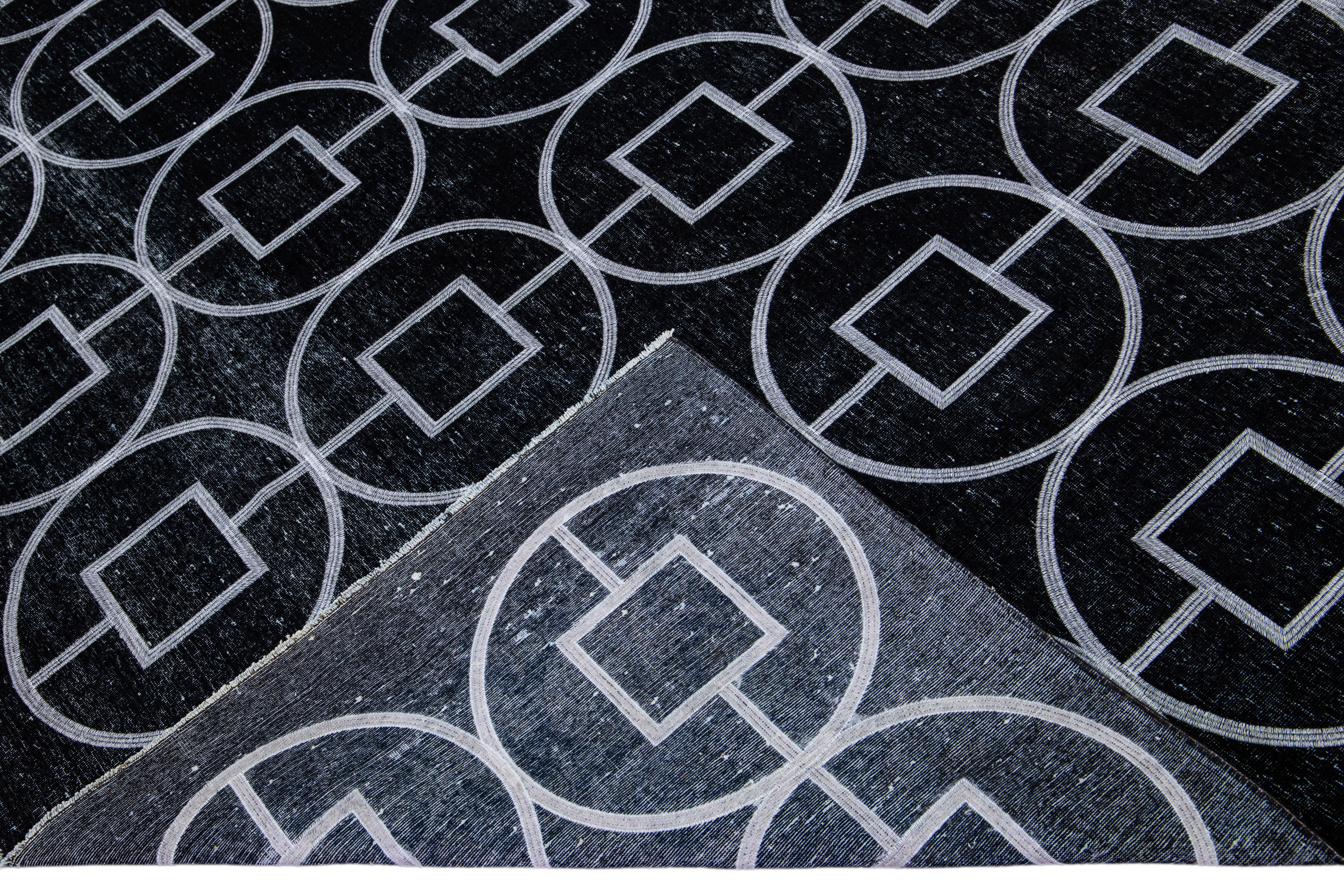 Beautiful Turkish handmade wool rug with a black distress look field. This Modern rug has white accents featuring a gorgeous all-over geometric pattern design.

This rug measures: 9'8