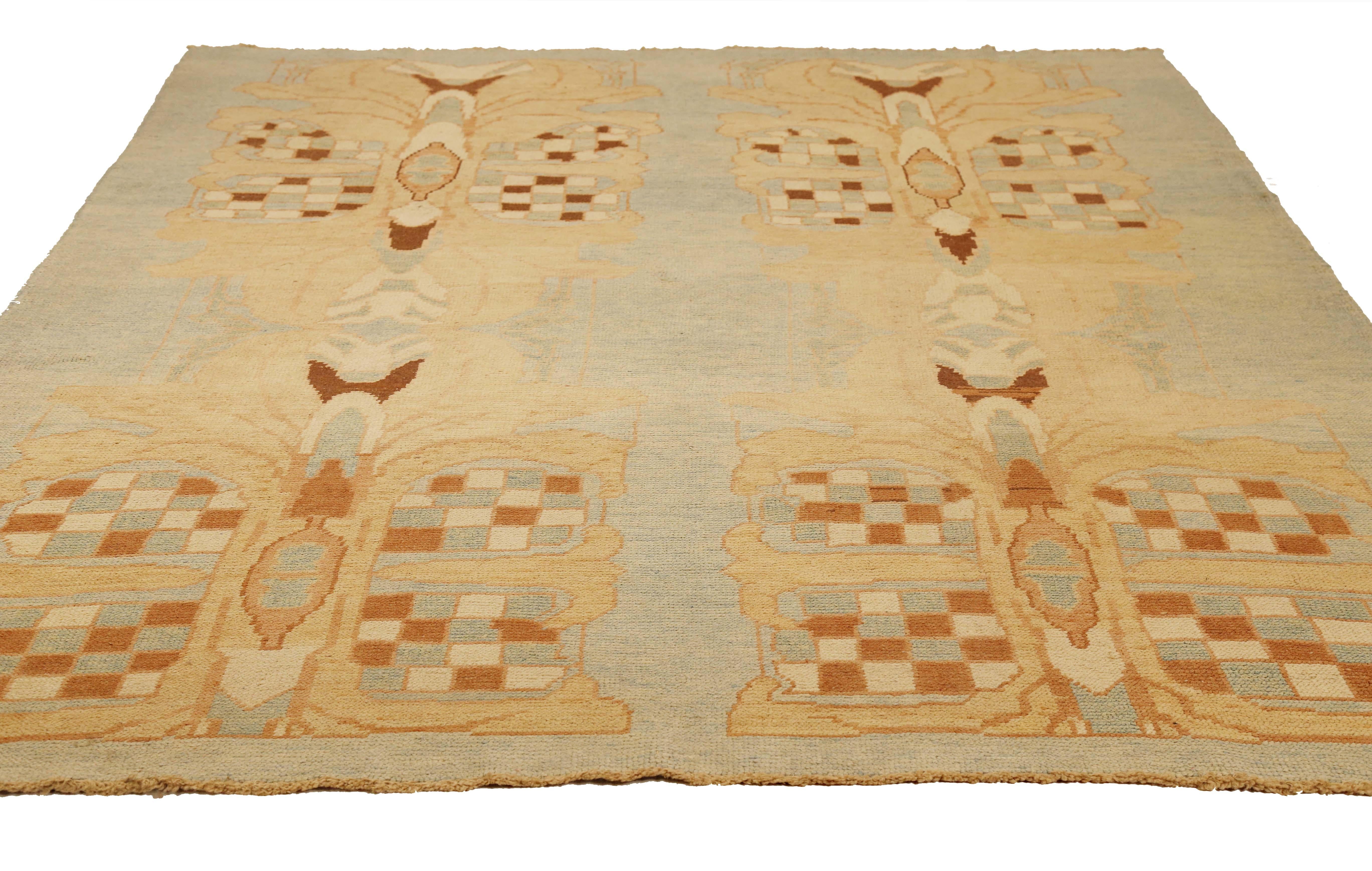 Modern handmade Turkish rug from high-quality sheep’s wool and colored with eco-friendly vegetable dyes that are proven safe for humans and pets alike. It’s a Donegal design showcasing a blue field with beautiful brown and beige botanical details.