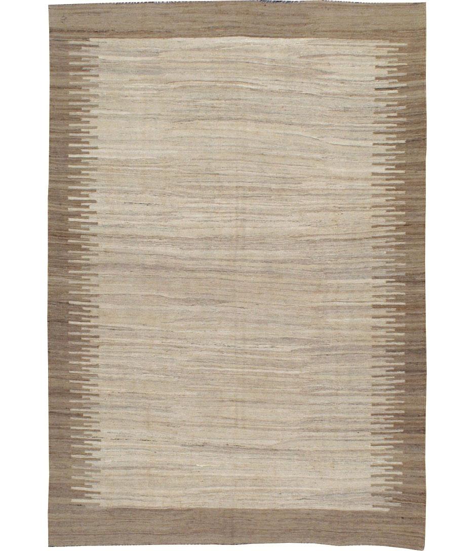 A contemporary Turkish flat-woven Kilim carpet from the fourth quarter of the 20th century. This rug was woven with repurposed old wool to give it a vintage look and feel.