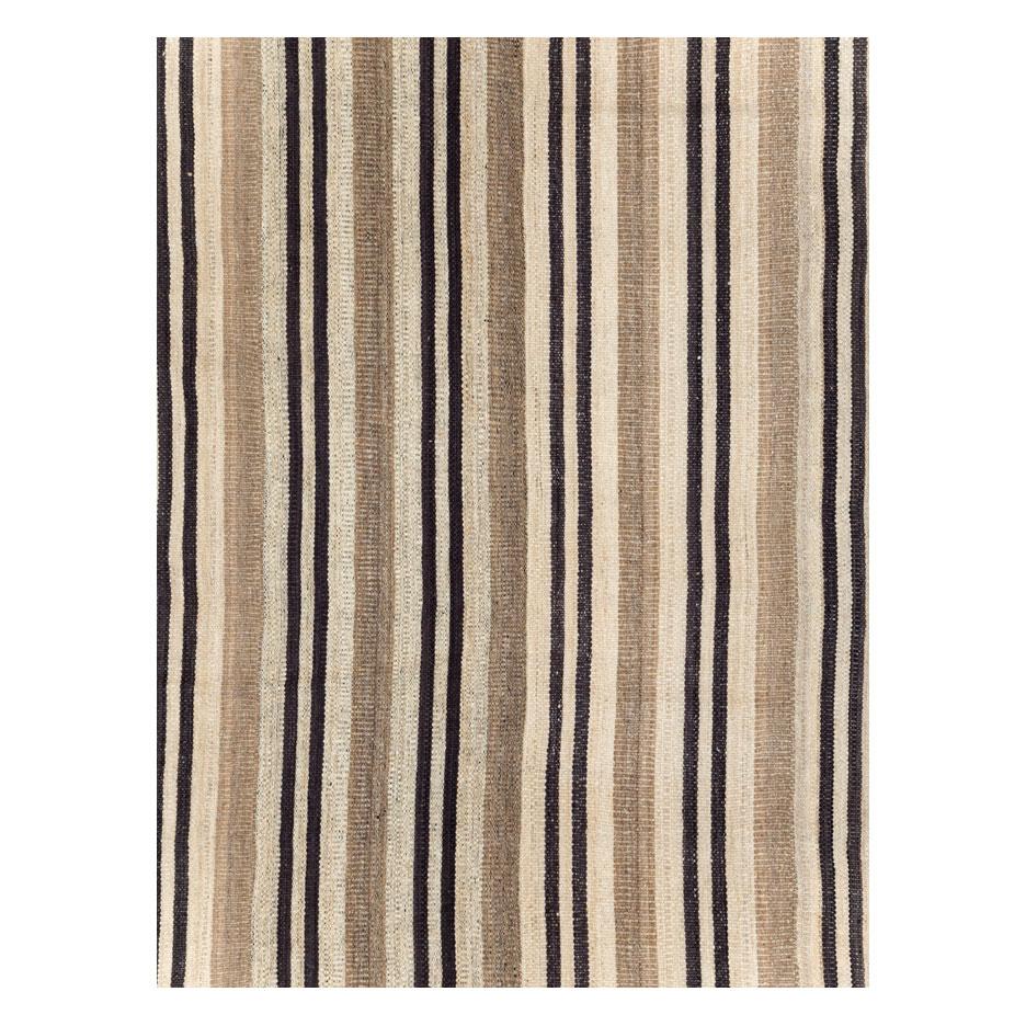 A modern Turkish flatweave Kilim room size carpet handmade during the 21st century in shades of cream, black, and light brown.

Measures: 9' 9