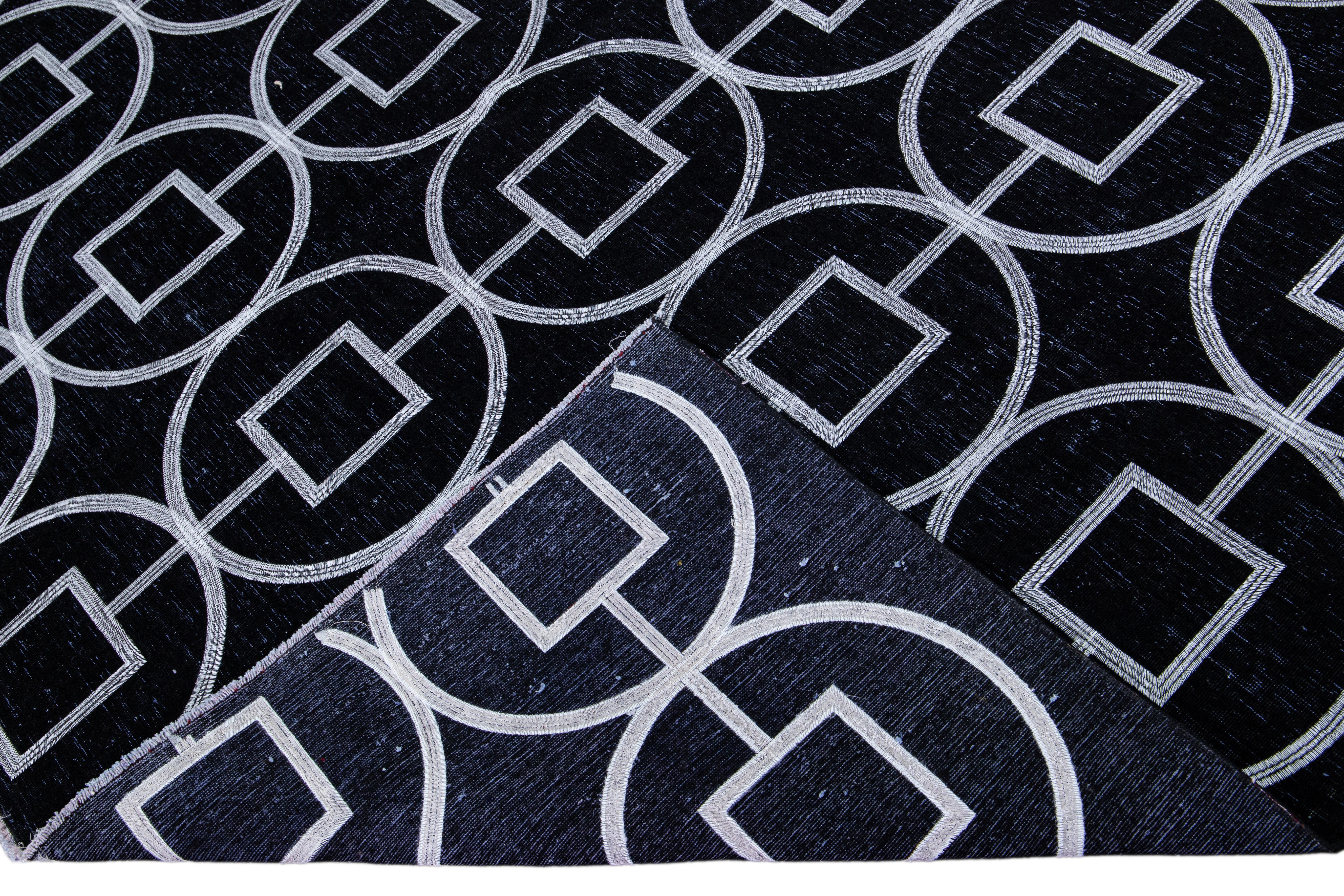Beautiful Turkish handmade wool rug with a black distress look field. This Modern rug has white accents featuring a gorgeous all-over geometric pattern design.

This rug measures: 8'1