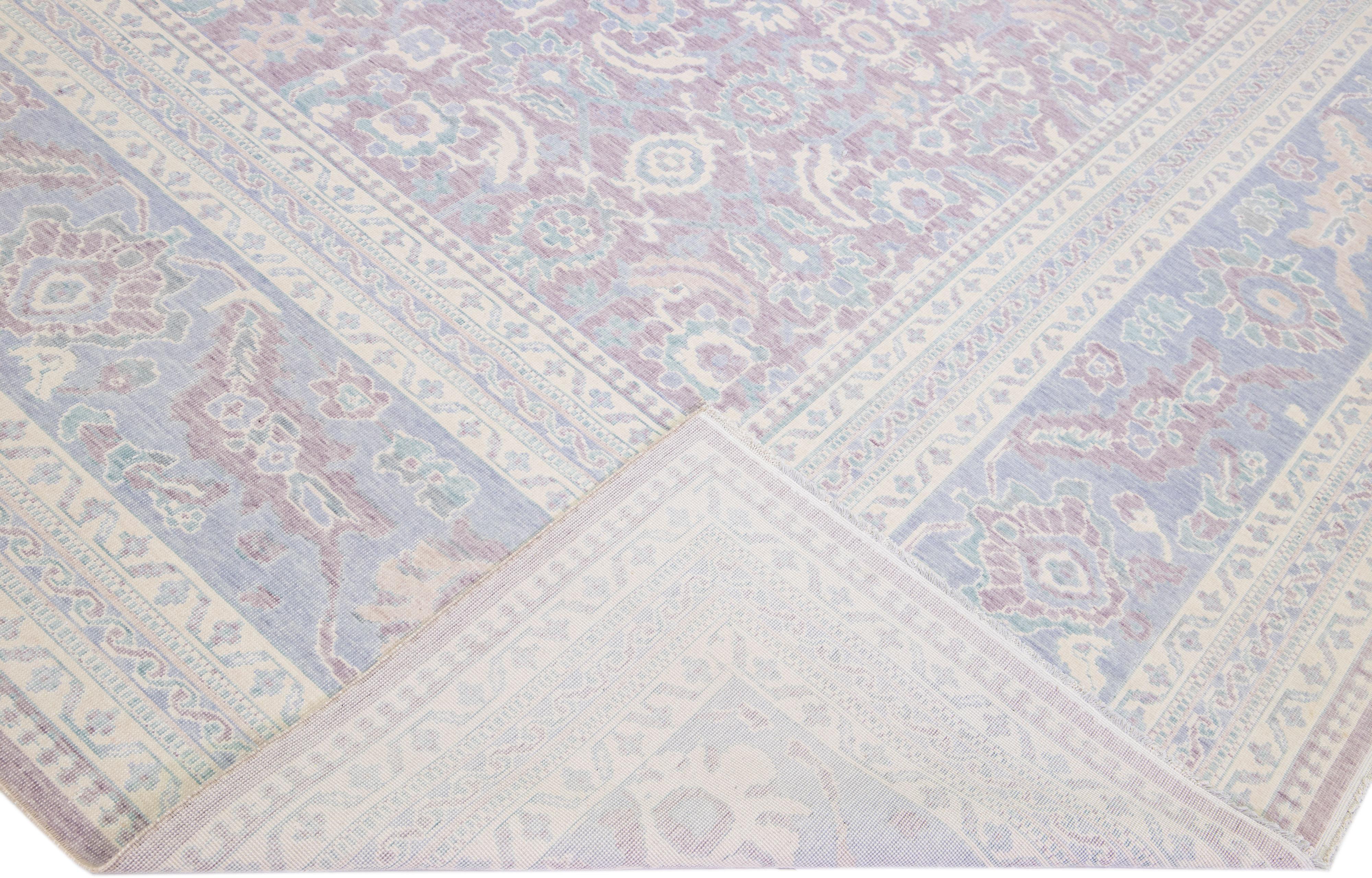 Beautiful modern Turkish hand-knotted wool rug with a light purple field. This piece has blue and beige accents in a gorgeous all-over floral pattern design.

This rug measures: 9'11