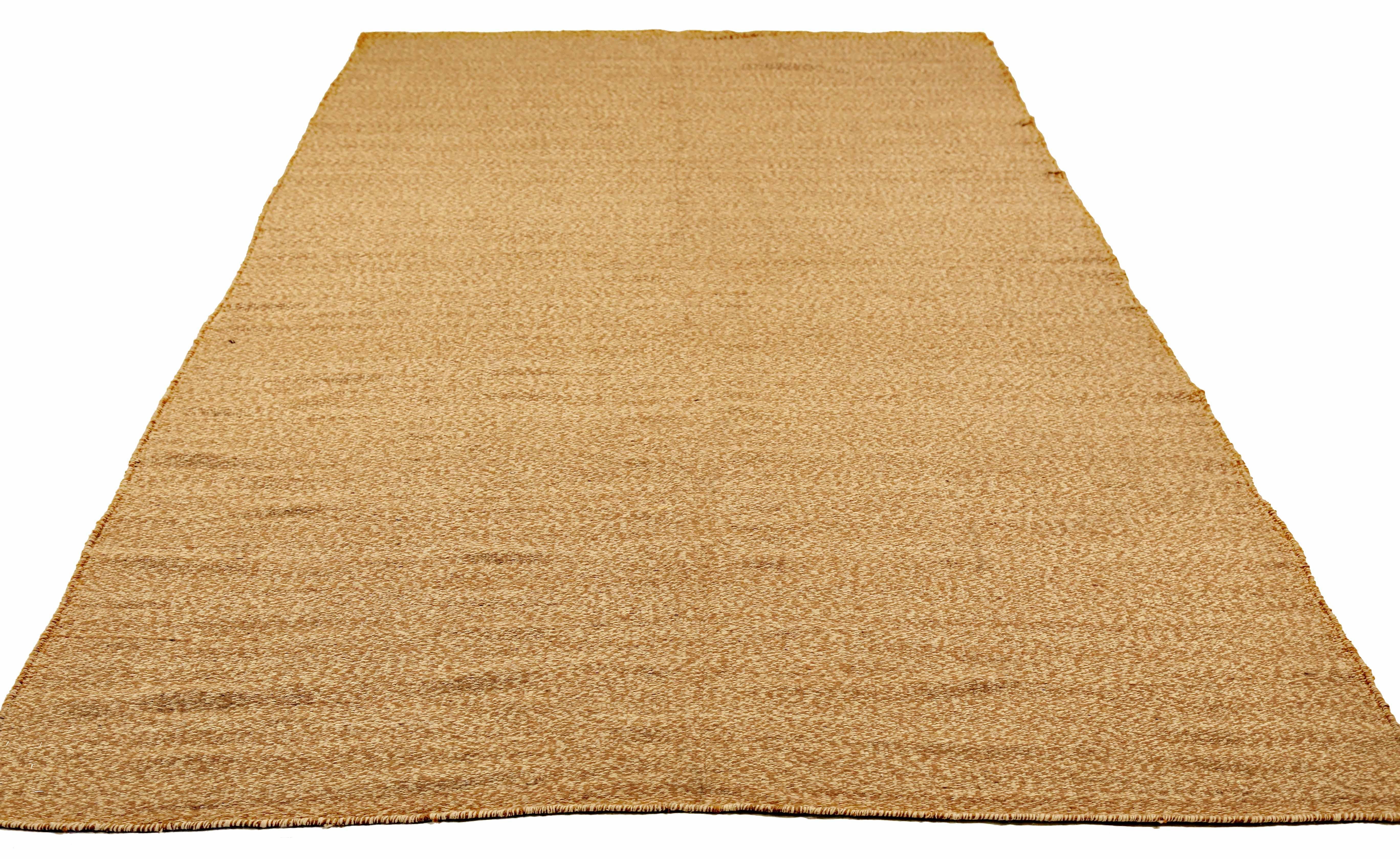 Modern Turkish rug handwoven from the finest sheep’s wool and colored with all-natural vegetable dyes that are safe for humans and pets. It’s a traditional Kilim flat-weave design featuring elegant color patterns of brown and ivory. It’s a stunning