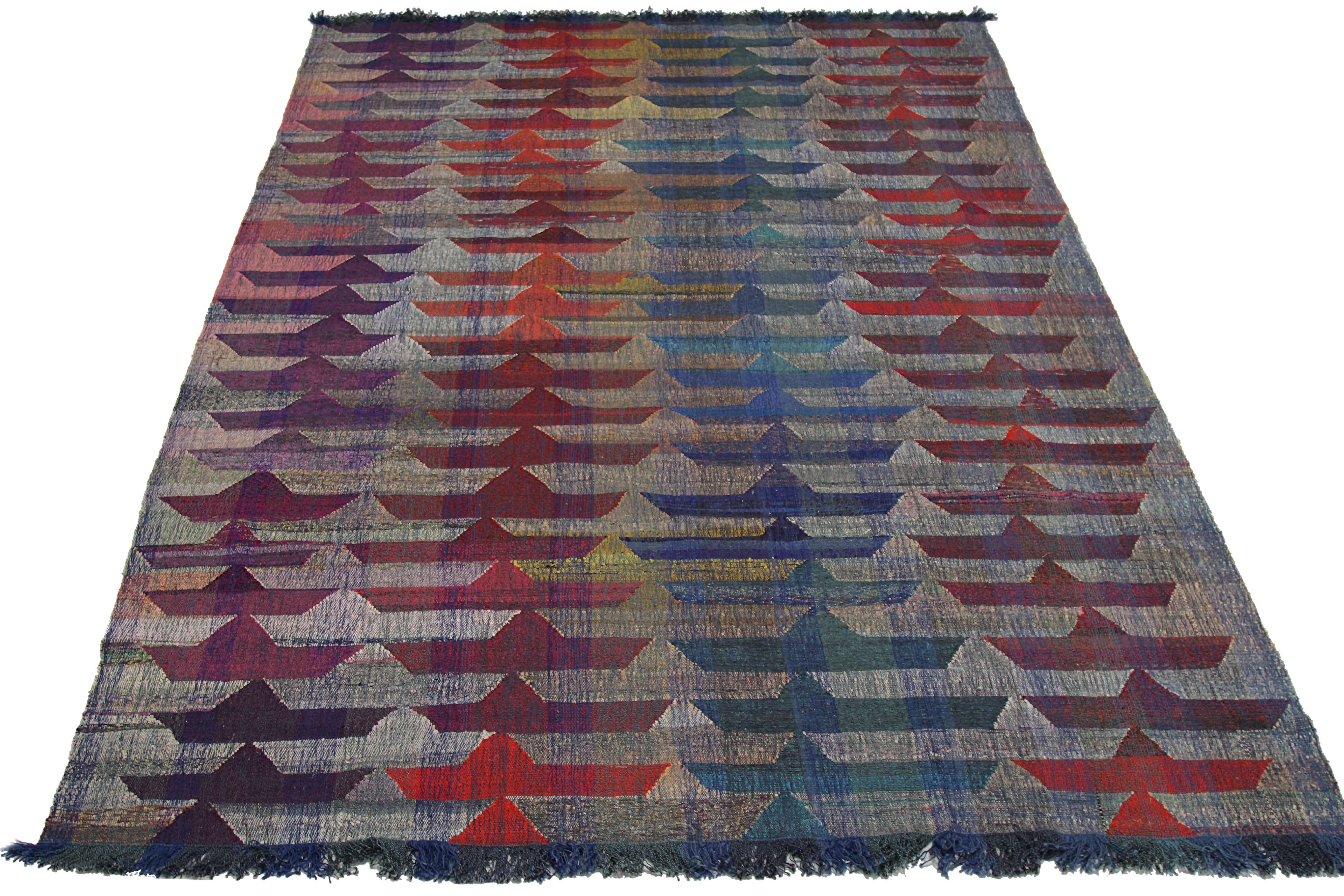 New Turkish rug handwoven from wool taken from antique fine carpets. 
It’s a traditional Kilim weaving featuring paper boat patterns in vibrant colors over an ivory field. It’s a stunning piece to get for contemporary and modern spaces. It has a