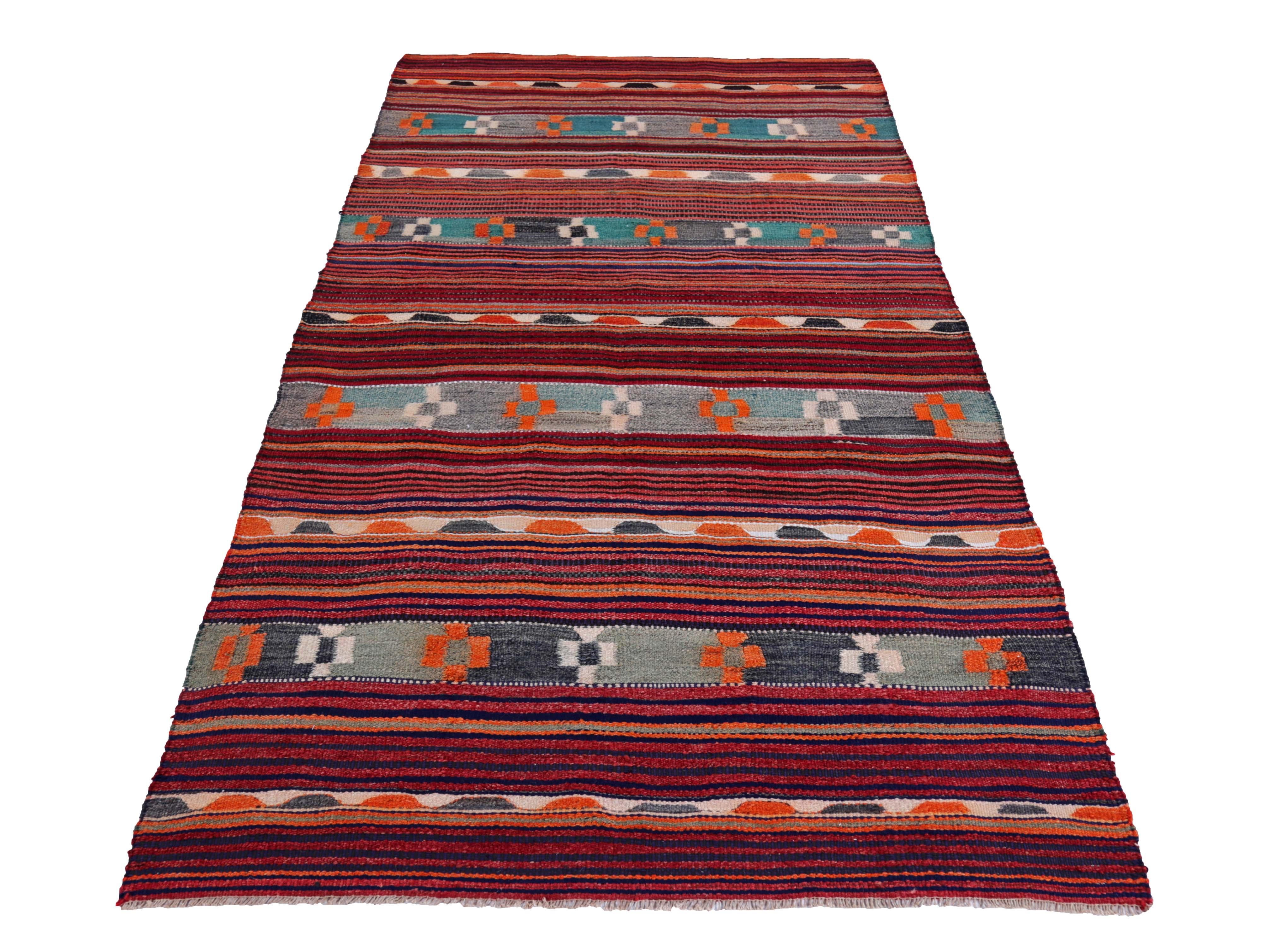 Turkish kilim rug handwoven from the finest sheep’s wool and colored with all-natural vegetable dyes that are safe for humans and pets. It’s a traditional Kilim flat-weave design featuring blue, green and orange tribal design patterns. It’s a