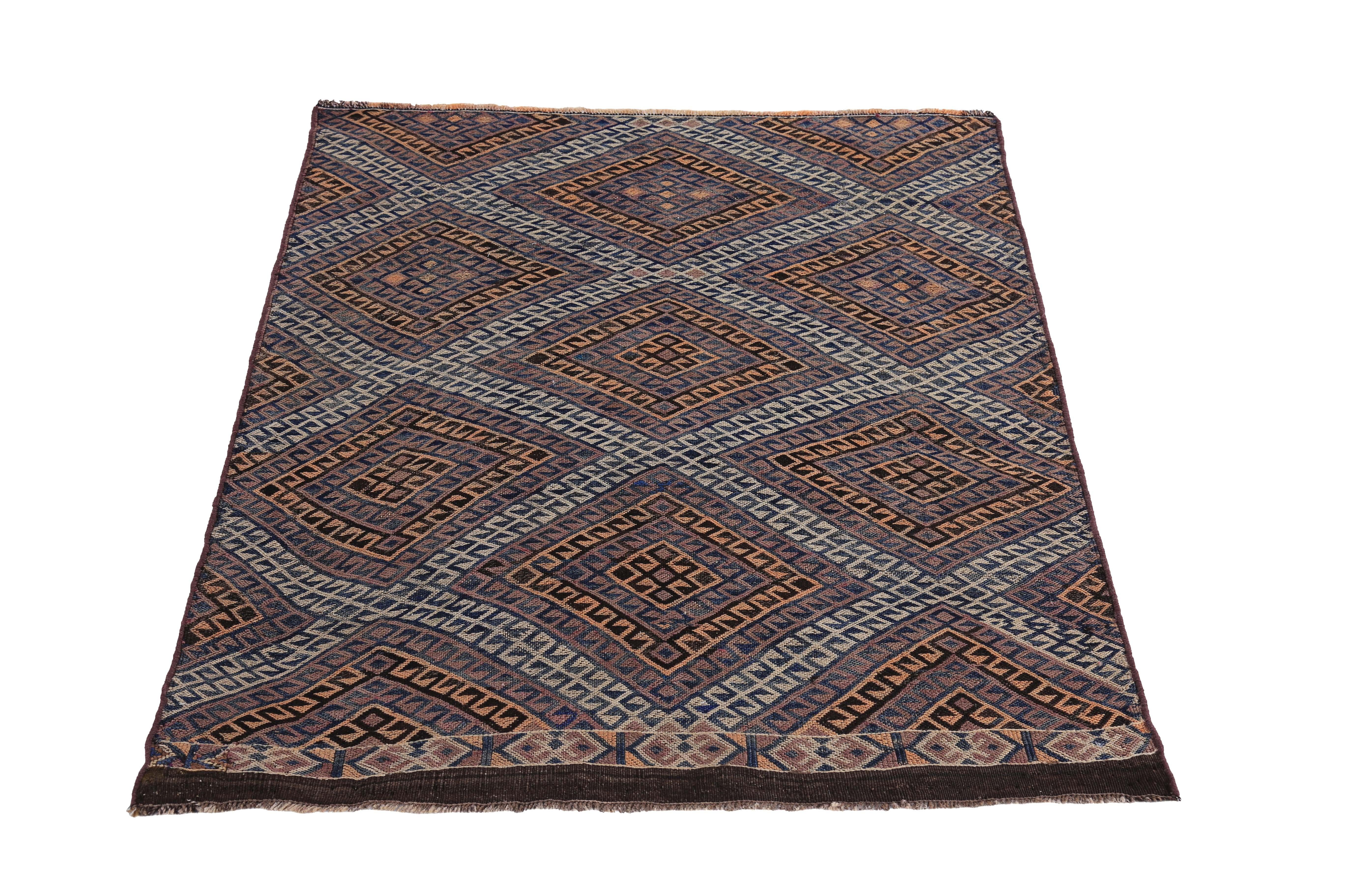 Turkish rug handwoven from the finest sheep’s wool and colored with all-natural vegetable dyes that are safe for humans and pets. It’s a traditional Kilim flat-weave design featuring brown, orange and beige diamond design patterns. It’s a stunning