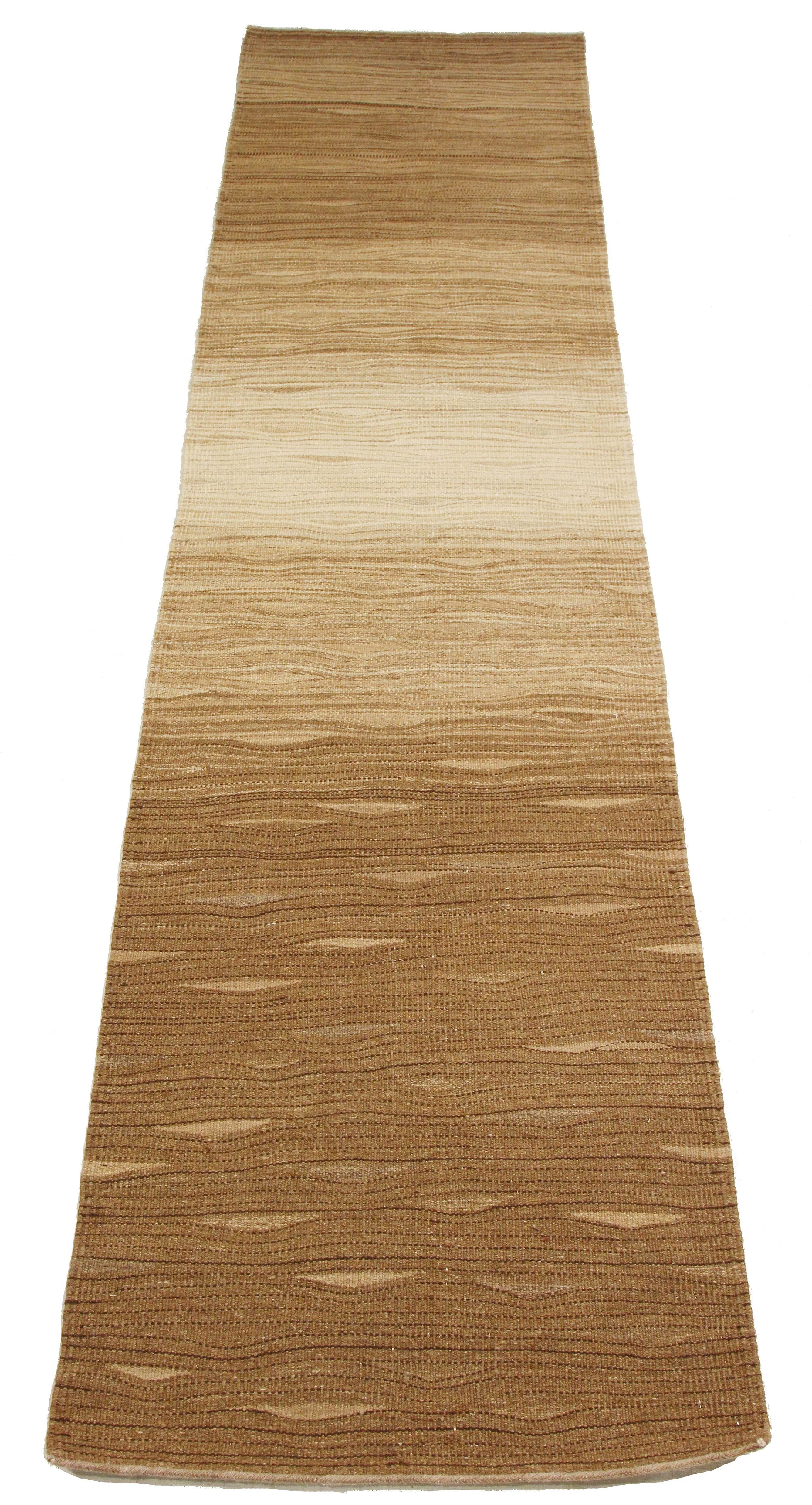 Modern Turkish runner rug handwoven from the finest sheep’s wool and colored with all-natural vegetable dyes that are safe for humans and pets. It’s a traditional Kilim flat-weave design featuring brown and beige ‘wood stain’ details on an ivory