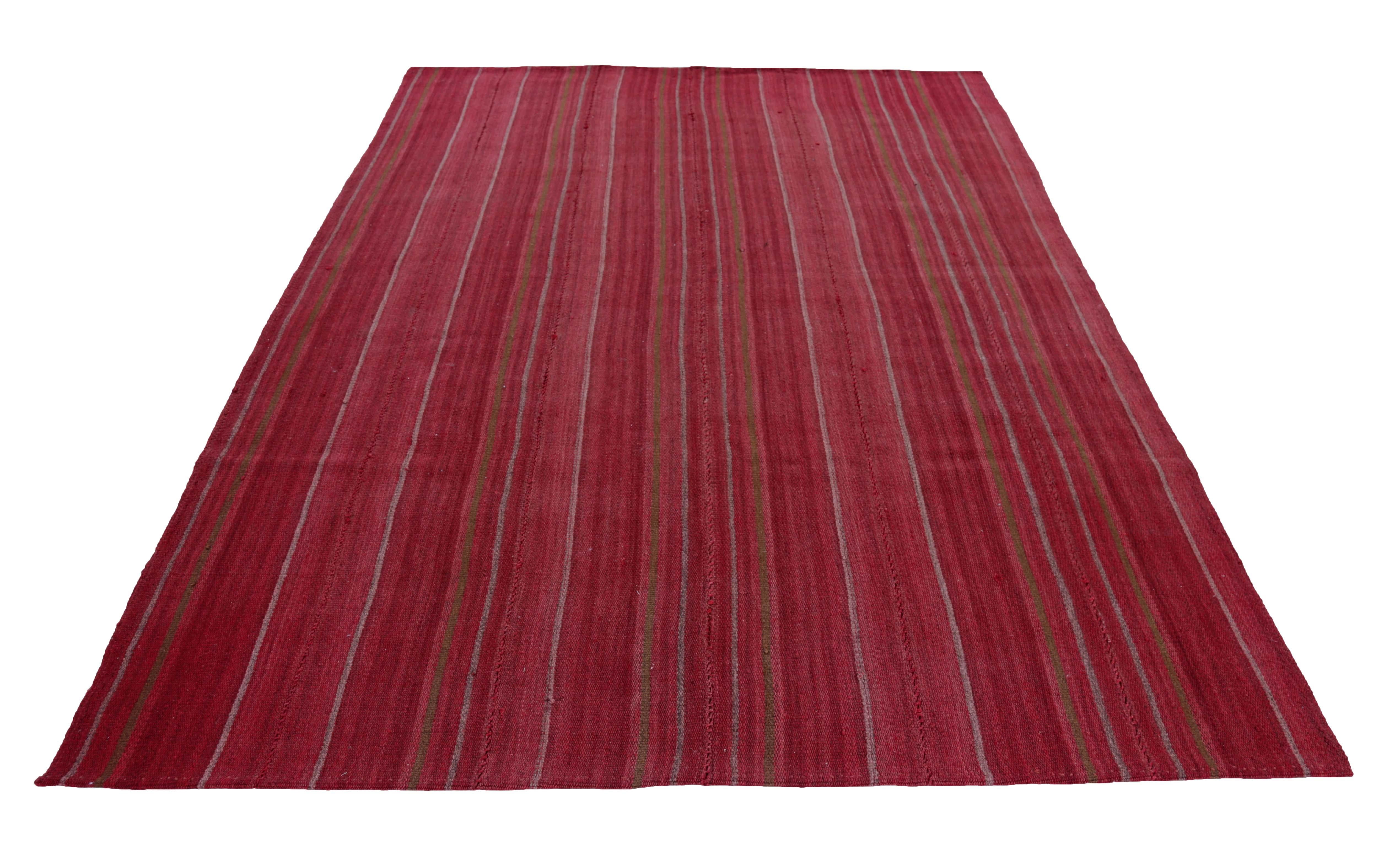 Modern Turkish rug handwoven from the finest sheep’s wool and colored with all-natural vegetable dyes that are safe for humans and pets. It’s a traditional Kilim flat-weave design featuring a red field with ivory and brown pencil stripes. It’s a