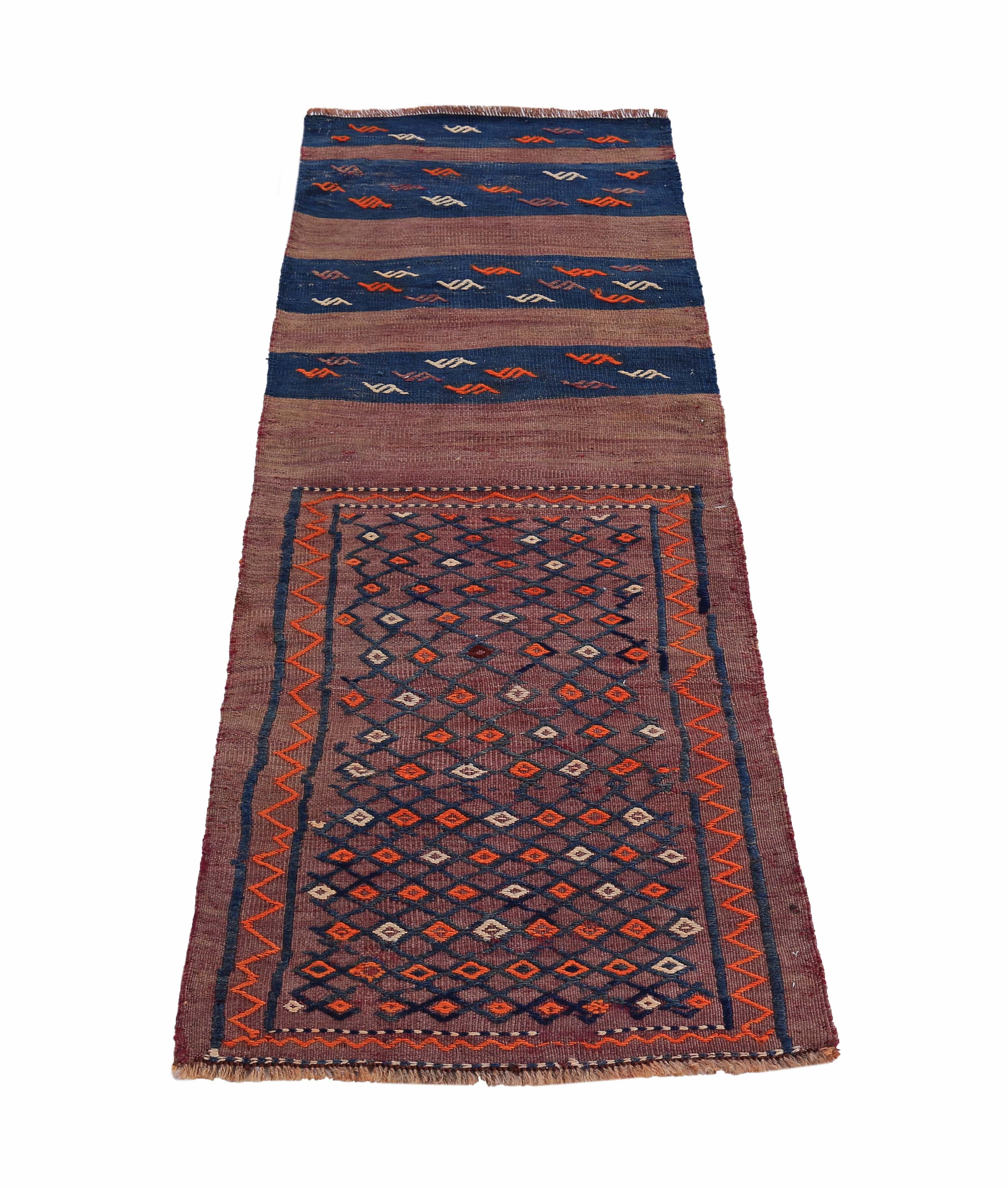 Turkish rug handwoven from the finest sheep’s wool and colored with all-natural vegetable dyes that are safe for humans and pets. It’s a traditional Kilim flat-weave design featuring navy and orange tribal design patterns on a red field. It’s a
