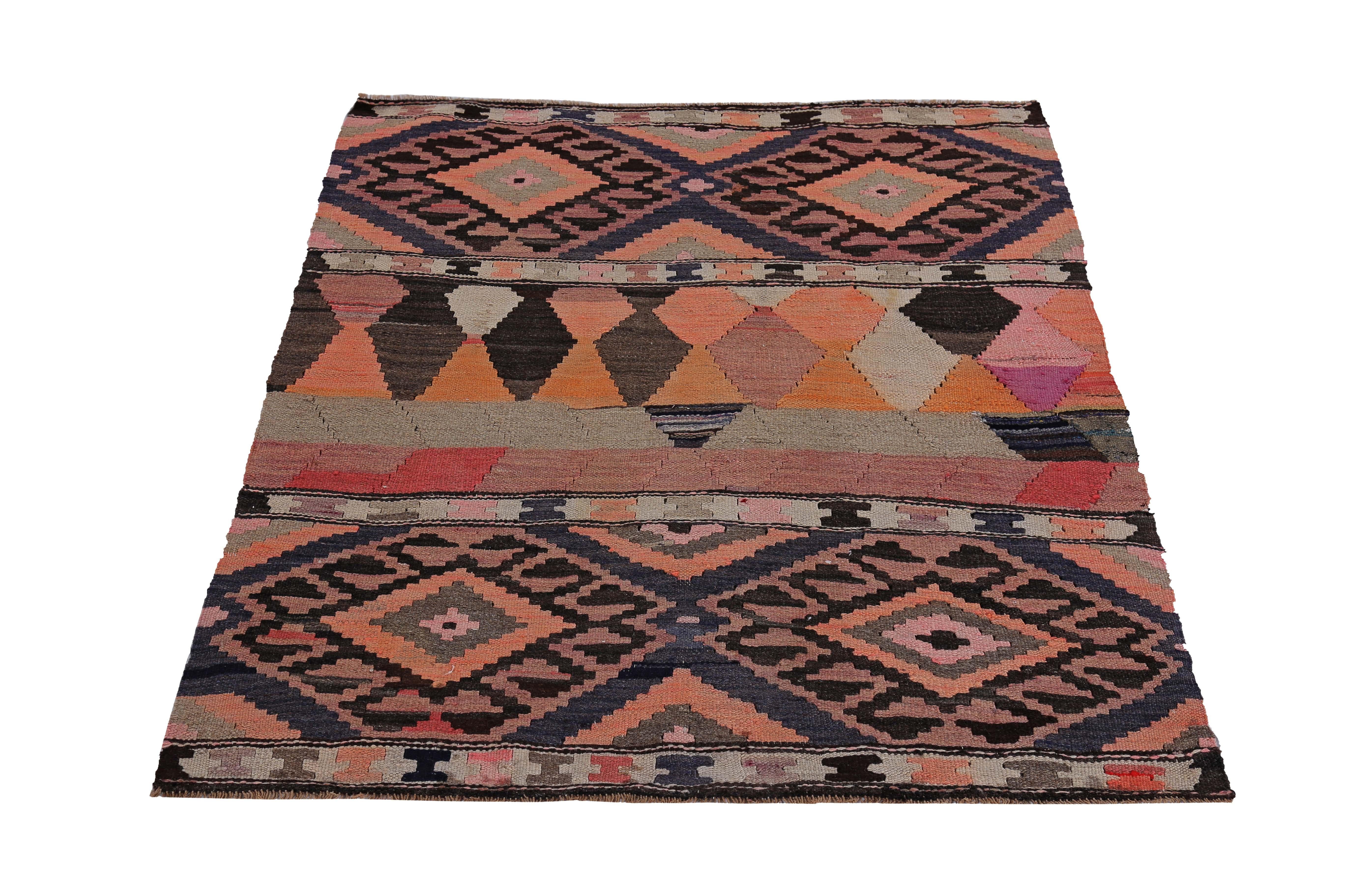 Turkish rug handwoven from the finest sheep’s wool and colored with all-natural vegetable dyes that are safe for humans and pets. It’s a traditional Kilim flat-weave design featuring orange, black, beige and brown tribal diamond patterns on a black