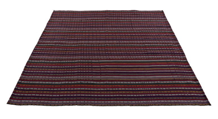 Turkish rug handwoven from the finest sheep’s wool and colored with all-natural vegetable dyes that are safe for humans and pets. It’s a traditional Kilim flat-weave design featuring orange, white, blue and red stripe patterns. It’s a stunning piece