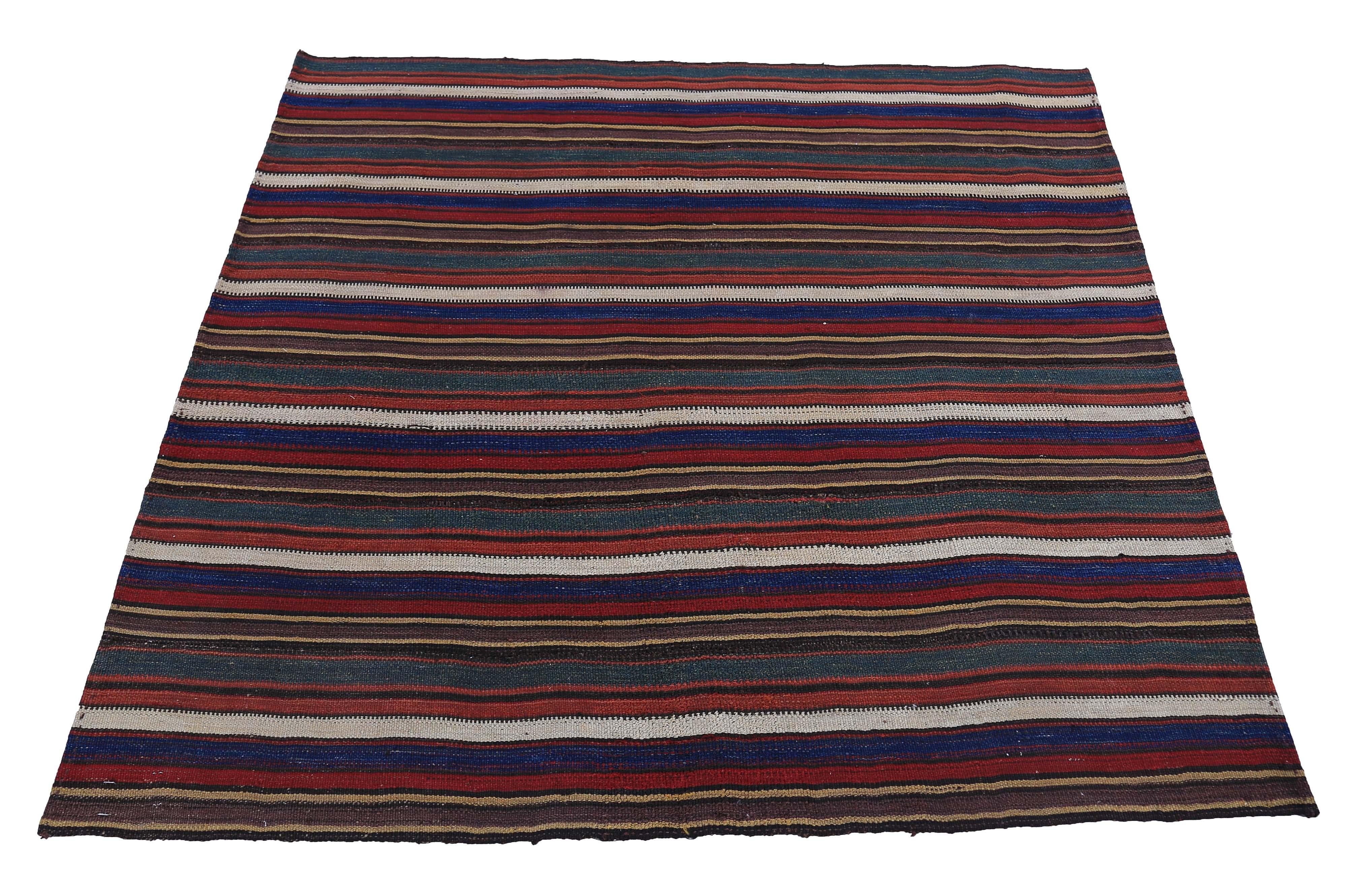 Modern Turkish rug handwoven from the finest sheep’s wool and colored with all-natural vegetable dyes that are safe for humans and pets. It’s a traditional Kilim flat-weave design featuring red, blue and beige stripes. It’s a stunning piece to get