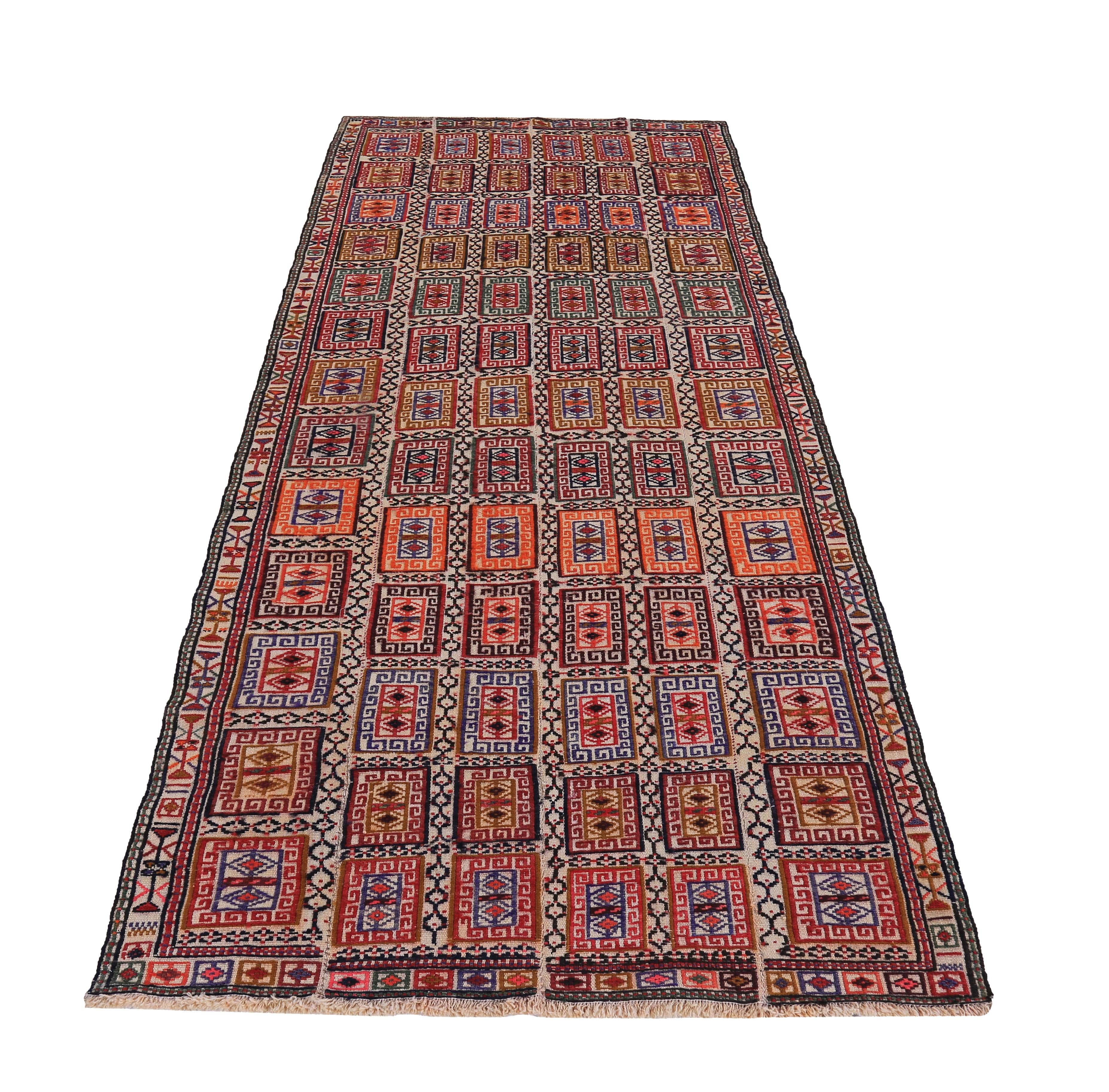 Turkish rug handwoven from the finest sheep’s wool and colored with all-natural vegetable dyes that are safe for humans and pets. It’s a traditional Kilim flat-weave design featuring red, blue and orange tribal blocks on a beige field. It’s a