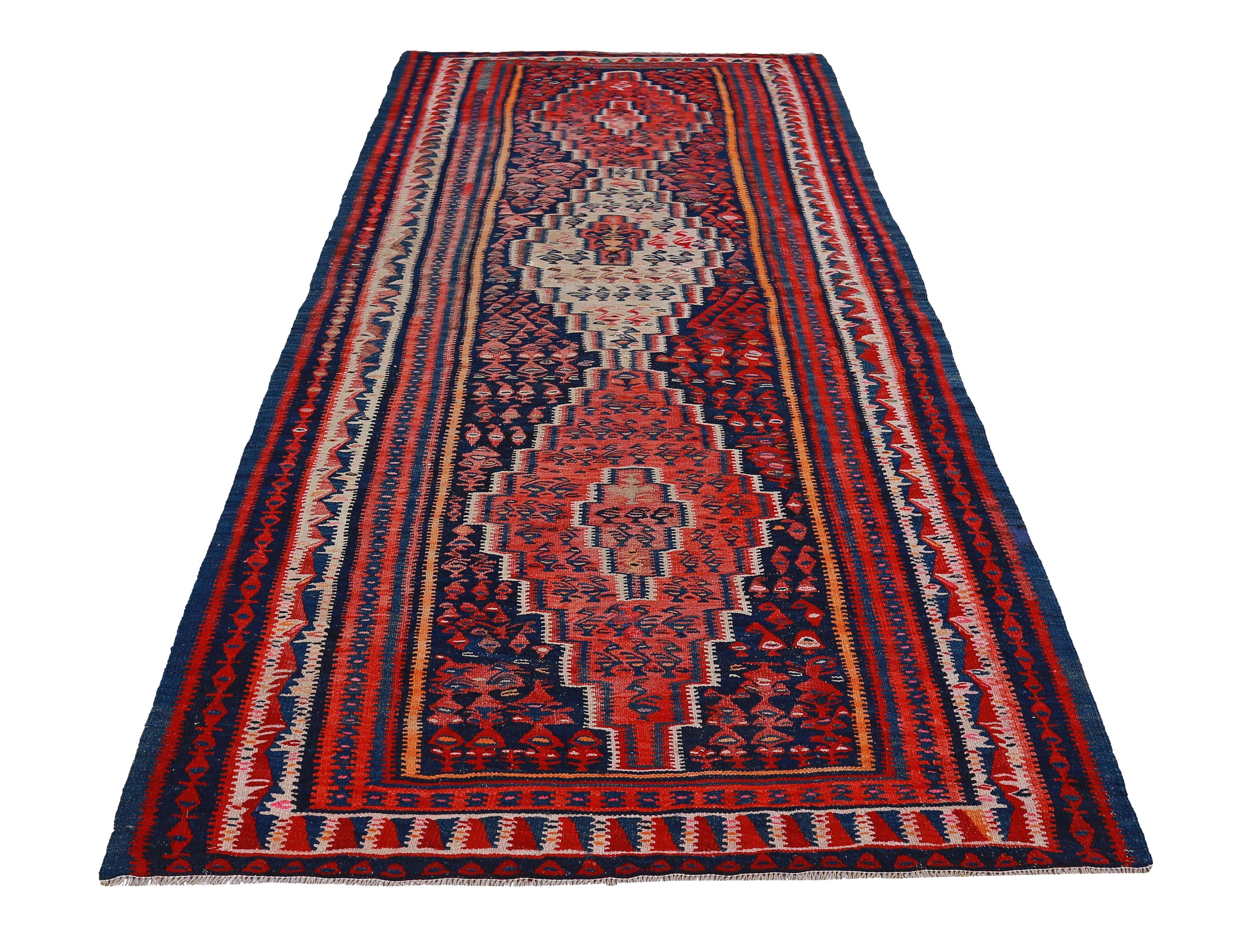 Turkish rug handwoven from the finest sheep’s wool and colored with all-natural vegetable dyes that are safe for humans and pets. It’s a traditional Kilim flat-weave design featuring red, blue and orange tribal stripes. It’s a stunning piece to get