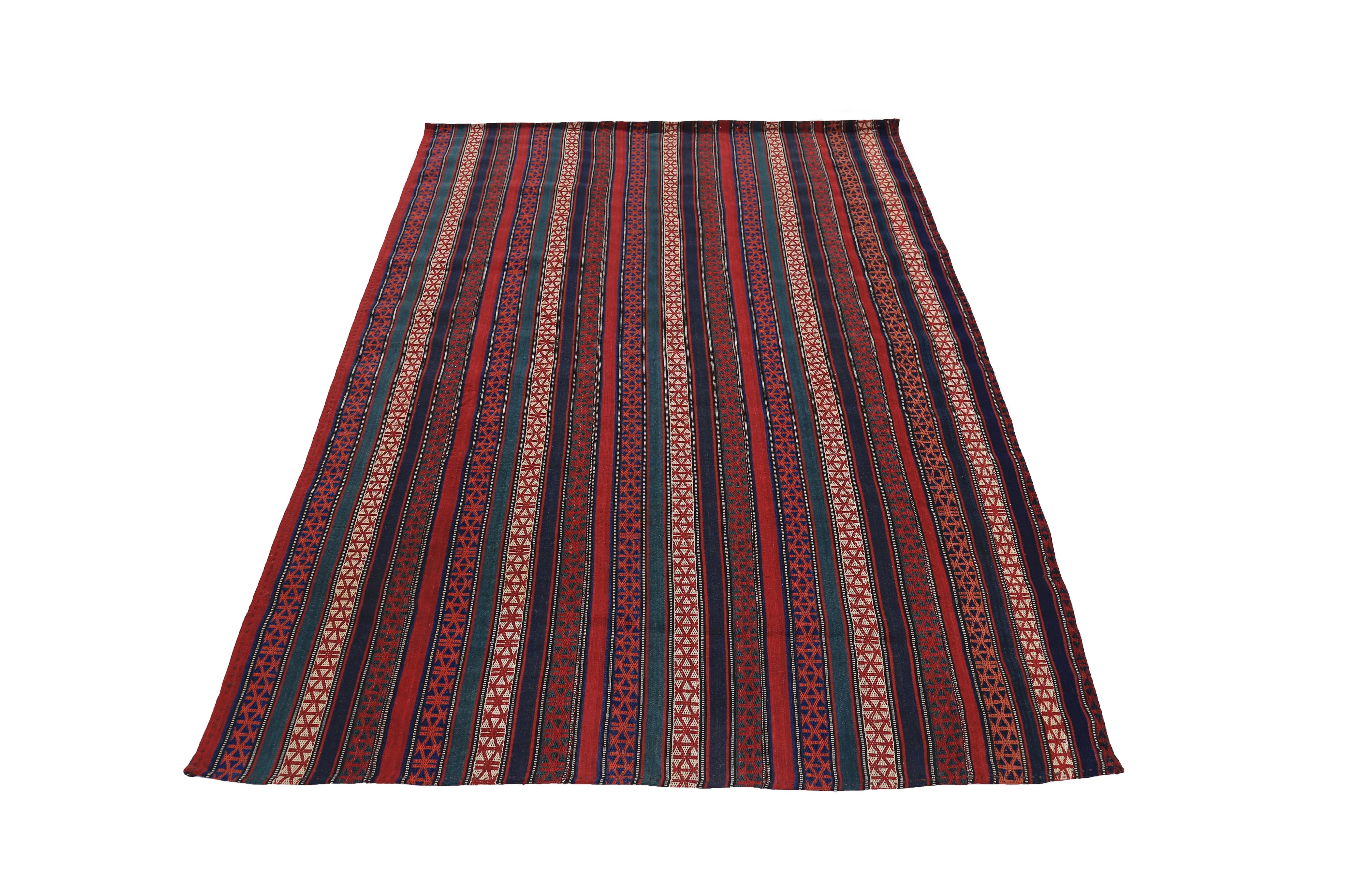 Turkish rug handwoven from the finest sheep’s wool and colored with all-natural vegetable dyes that are safe for humans and pets. It’s a traditional Kilim flat-weave design featuring red, beige and blue stripes with tribal design patterns. It’s a