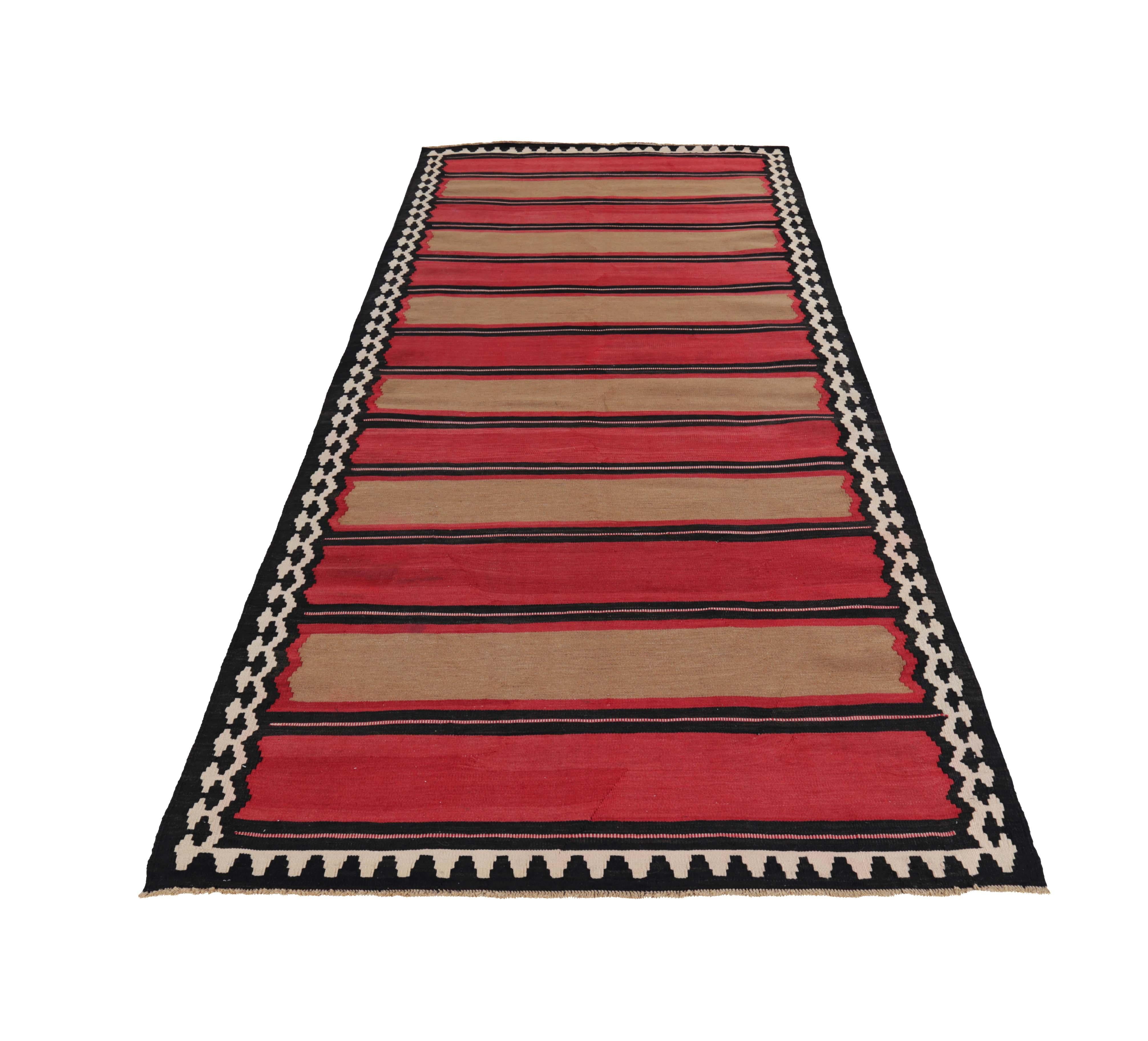Turkish rug handwoven from the finest sheep’s wool and colored with all-natural vegetable dyes that are safe for humans and pets. It’s a traditional Kilim flat-weave design featuring red and brown block stripes in a black field. It’s a stunning
