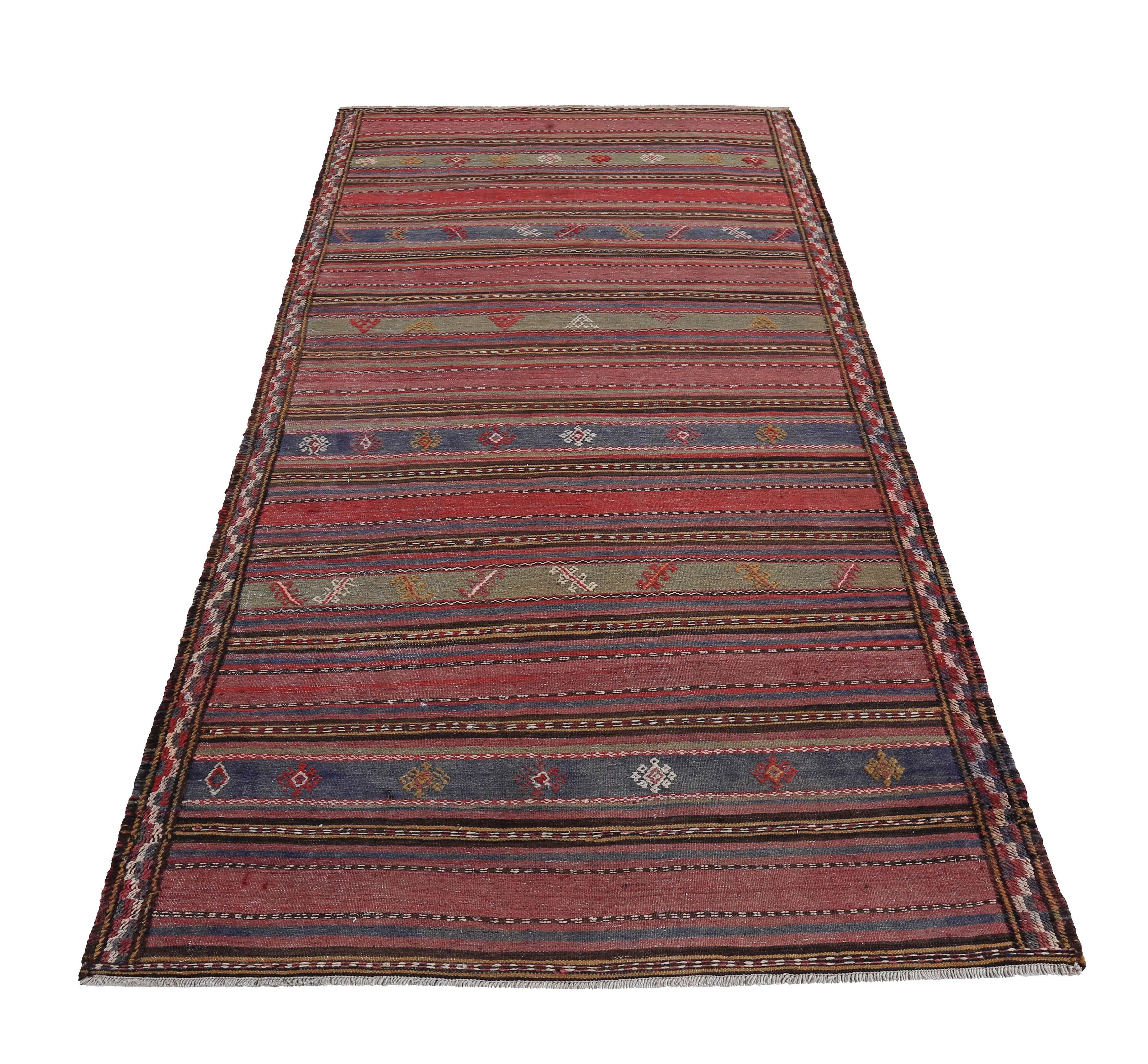 Modern Turkish rug handwoven from the finest sheep’s wool and colored with all-natural vegetable dyes that are safe for humans and pets. It’s a traditional Kilim flat-weave design featuring a brown field with red, green and navy stripes. It’s a