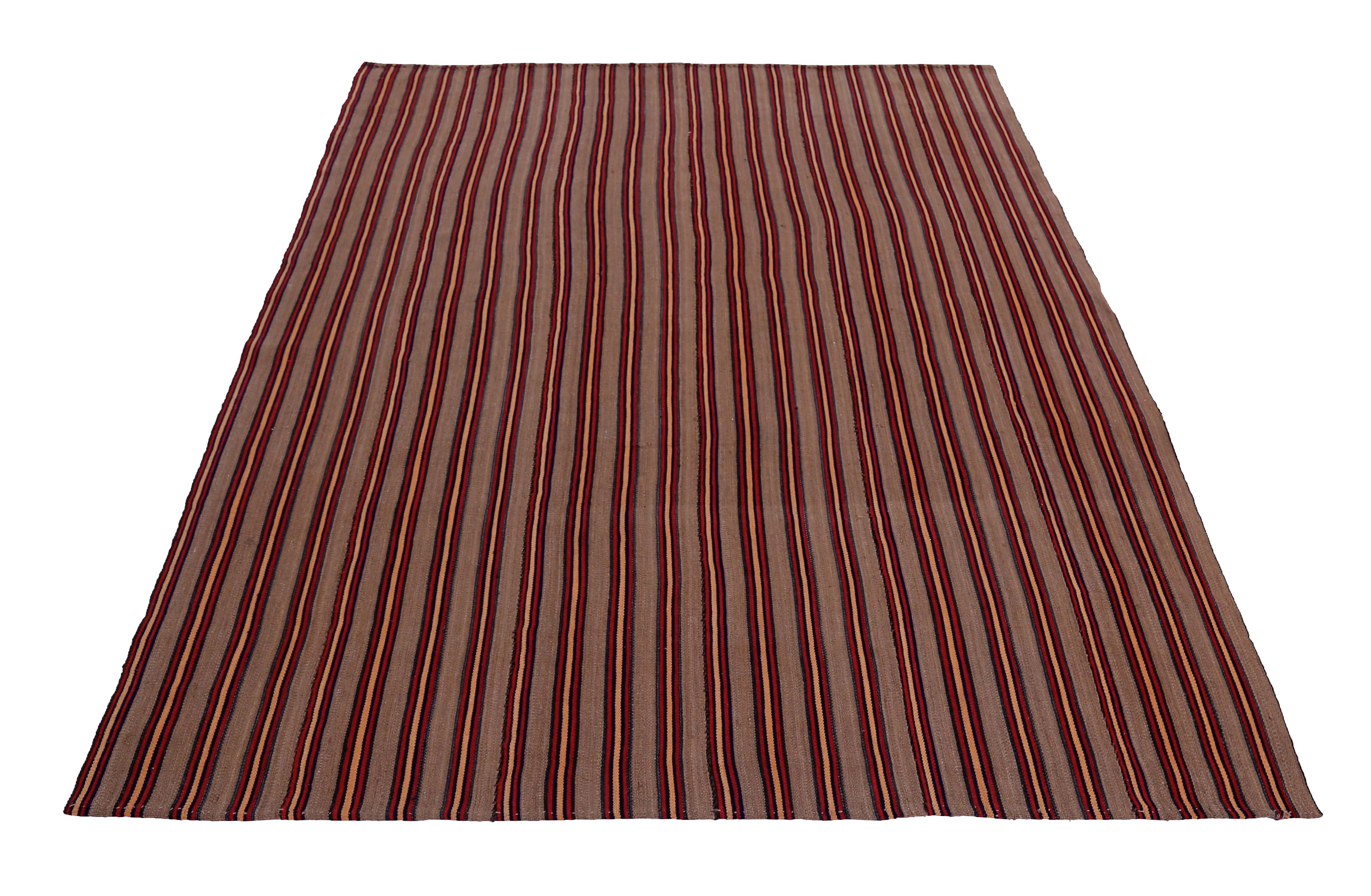 Turkish rug handwoven from the finest sheep’s wool and colored with all-natural vegetable dyes that are safe for humans and pets. It’s a traditional Kilim flat-weave design featuring red, orange and black pencil stripes in a beige field. It’s a