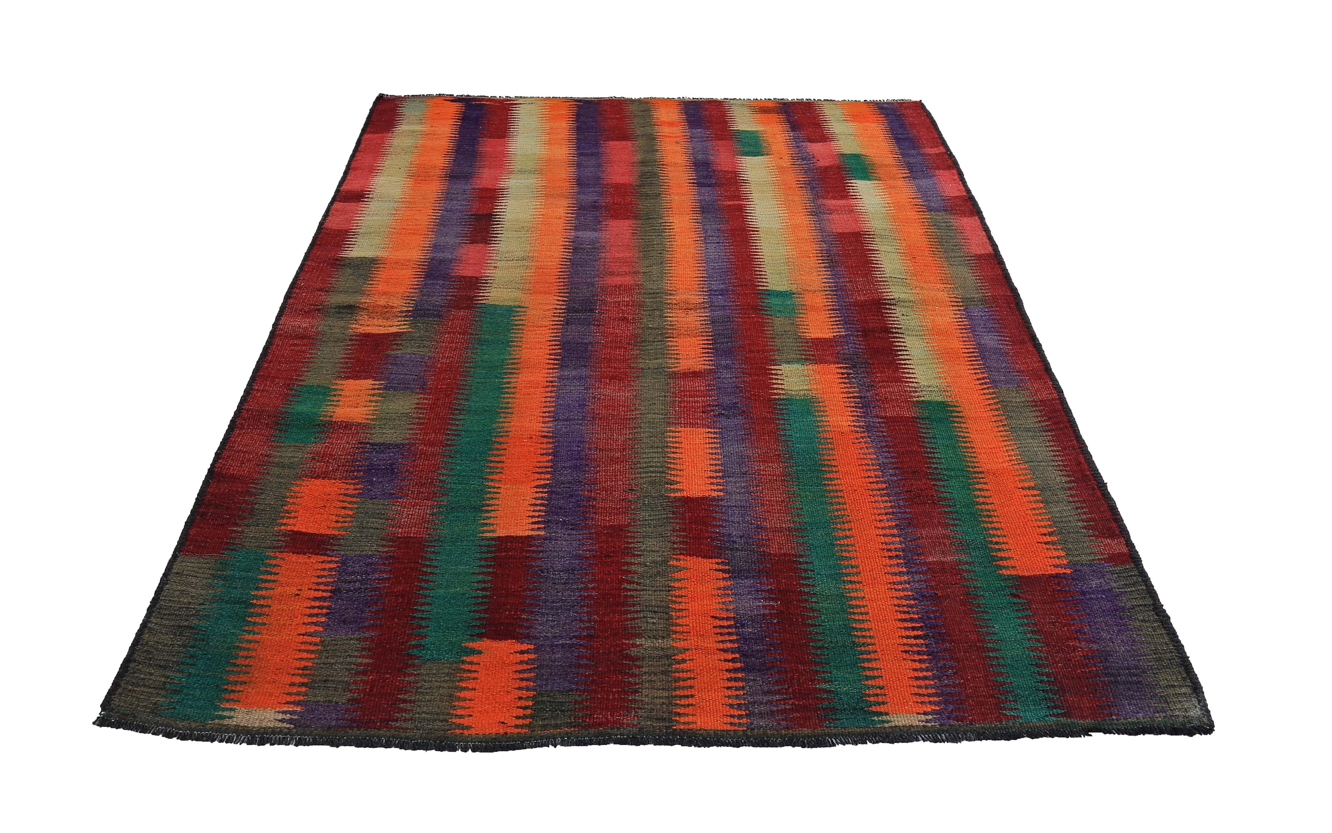 Turkish rug handwoven from the finest sheep’s wool and colored with all-natural vegetable dyes that are safe for humans and pets. It’s a traditional Kilim flat-weave design featuring red, orange and green tribal stripes. It’s a stunning piece to get