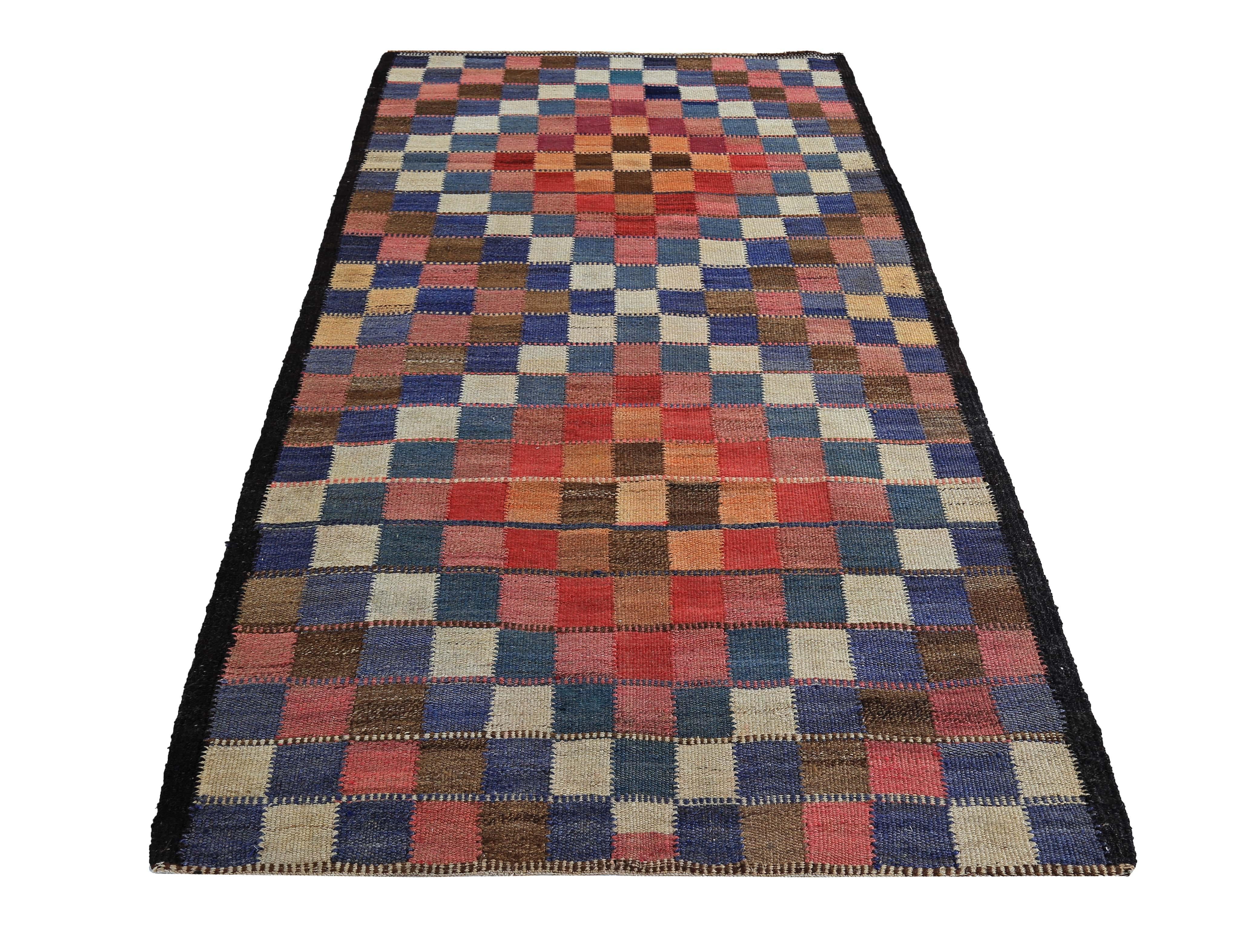 Turkish rug handwoven from the finest sheep’s wool and colored with all-natural vegetable dyes that are safe for humans and pets. It’s a traditional Kilim flat-weave design featuring red, pink and blue checkered design. It’s a stunning piece to get