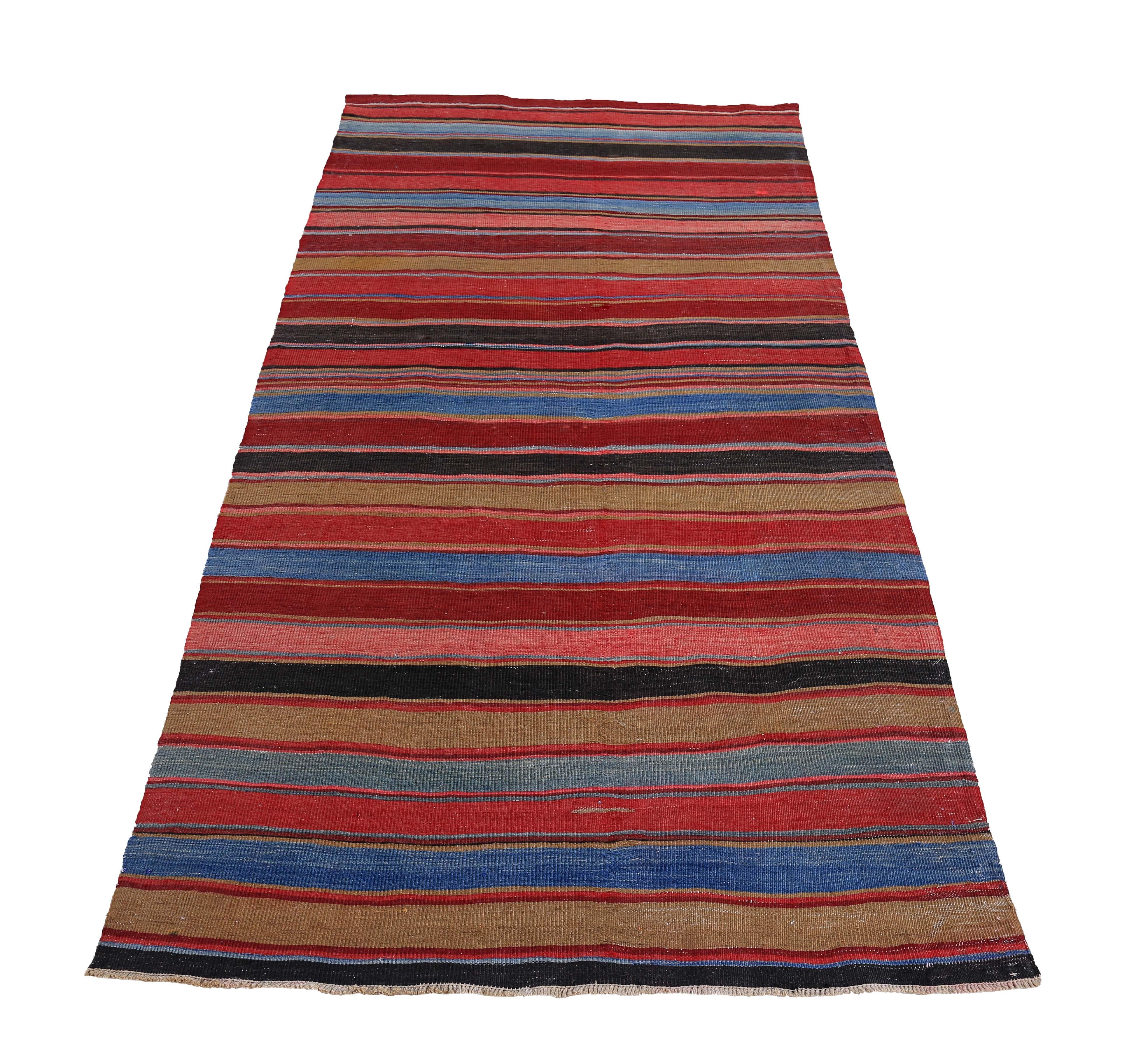 Turkish rug handwoven from the finest sheep’s wool and colored with all-natural vegetable dyes that are safe for humans and pets. It’s a traditional Kilim flat-weave design featuring red, pink and blue stripes. It’s a stunning piece to get for
