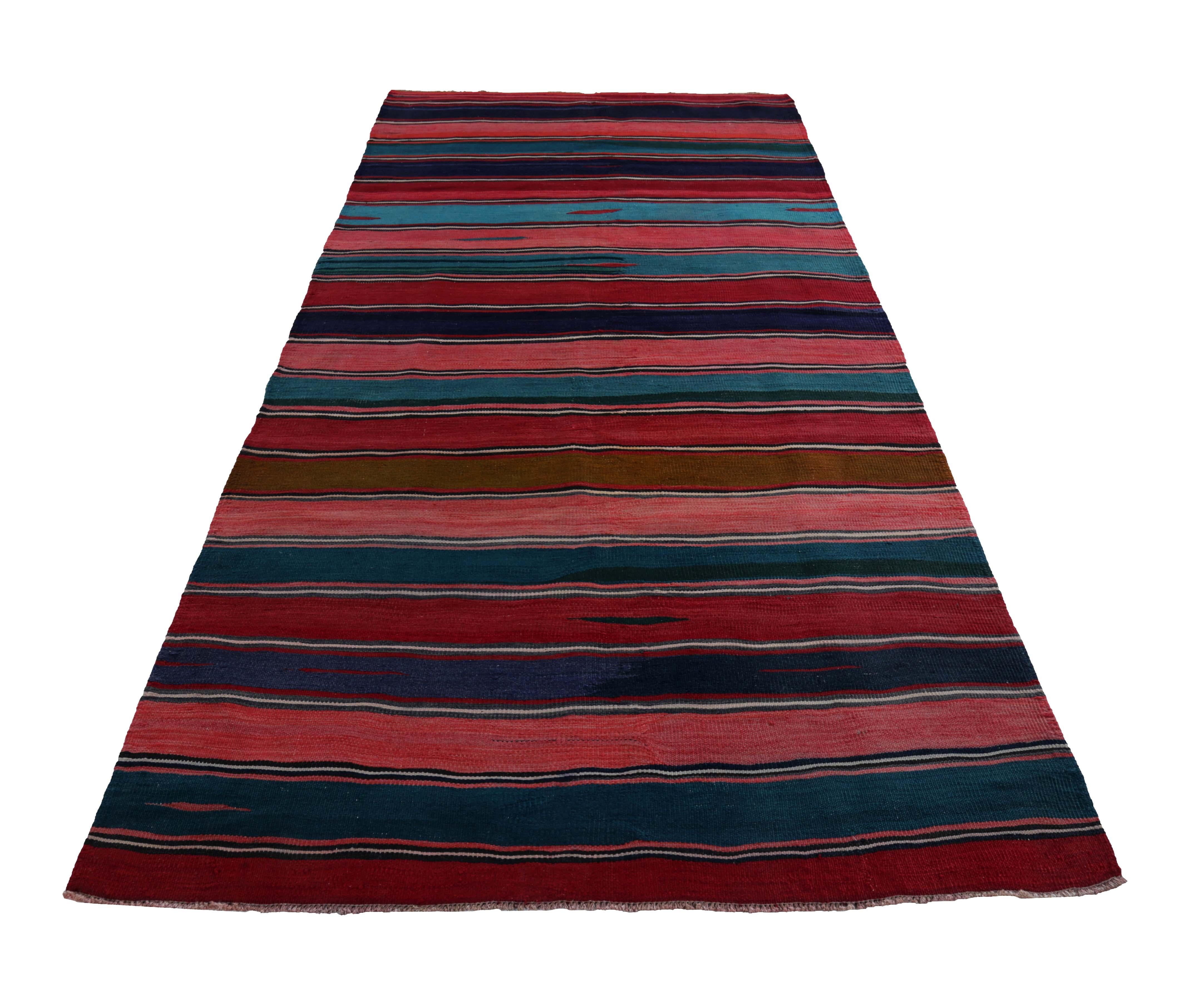 Turkish rug handwoven from the finest sheep’s wool and colored with all-natural vegetable dyes that are safe for humans and pets. It’s a traditional Kilim flat-weave design featuring red, pink and blue stripes. It’s a stunning piece to get for