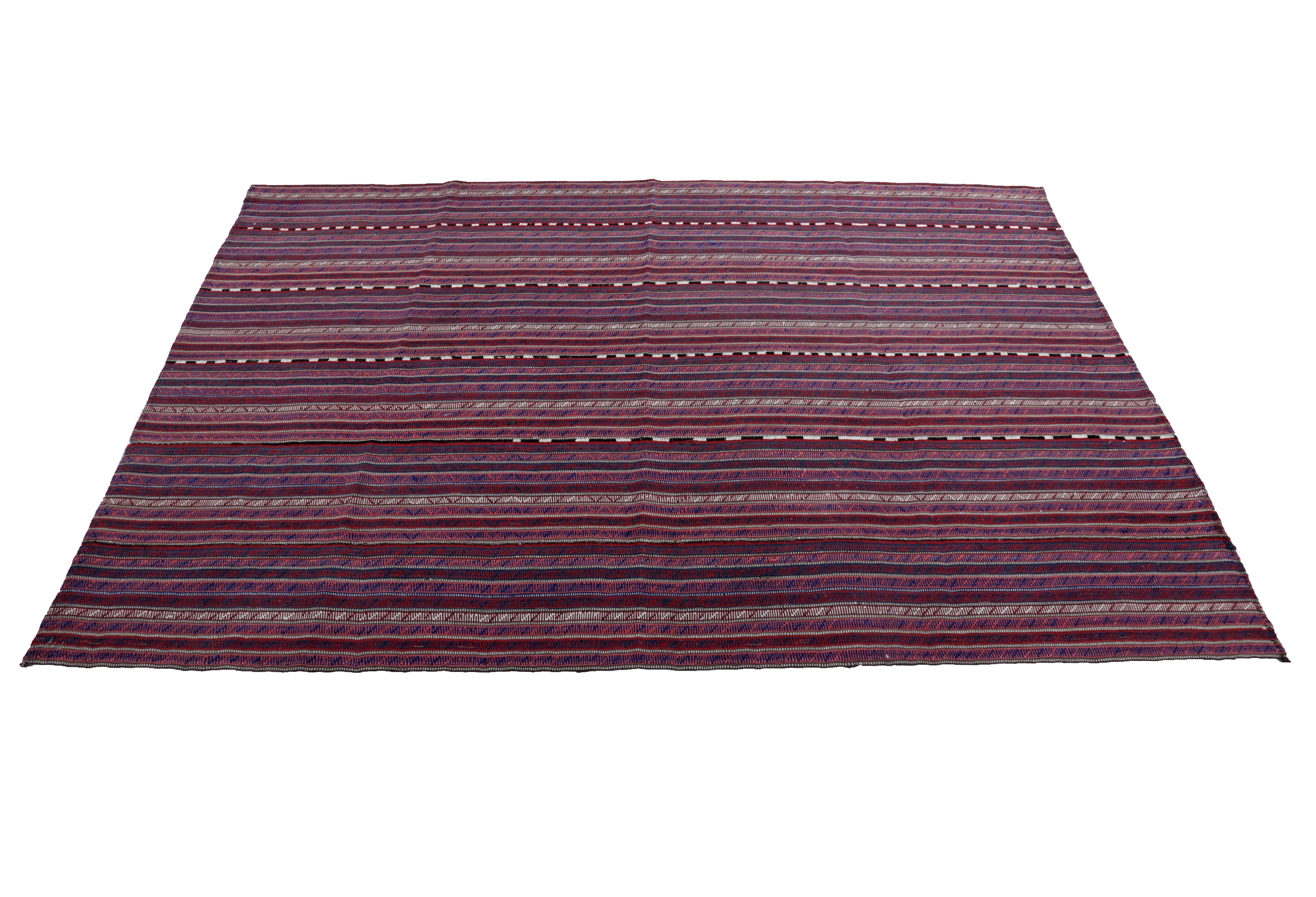 Turkish rug handwoven from the finest sheep’s wool and colored with all-natural vegetable dyes that are safe for humans and pets. It’s a traditional Kilim flat-weave design featuring red, pink, and white stripes. It’s a stunning piece to get for