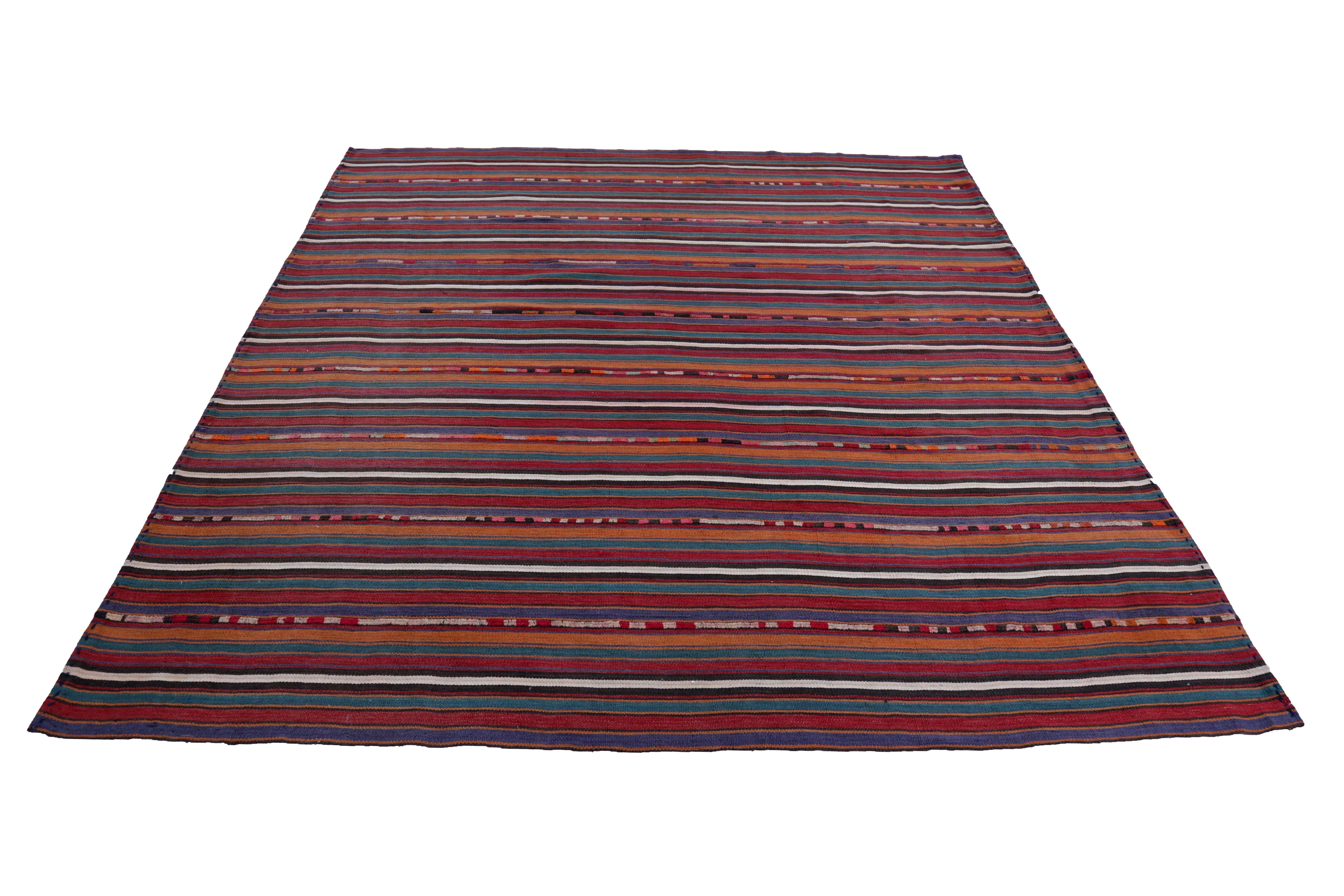 Turkish kilim rug handwoven from the finest sheep’s wool and colored with all-natural vegetable dyes that are safe for humans and pets. It’s a traditional Kilim flat-weave design featuring red, white and orange pencil stripes. It’s a stunning piece