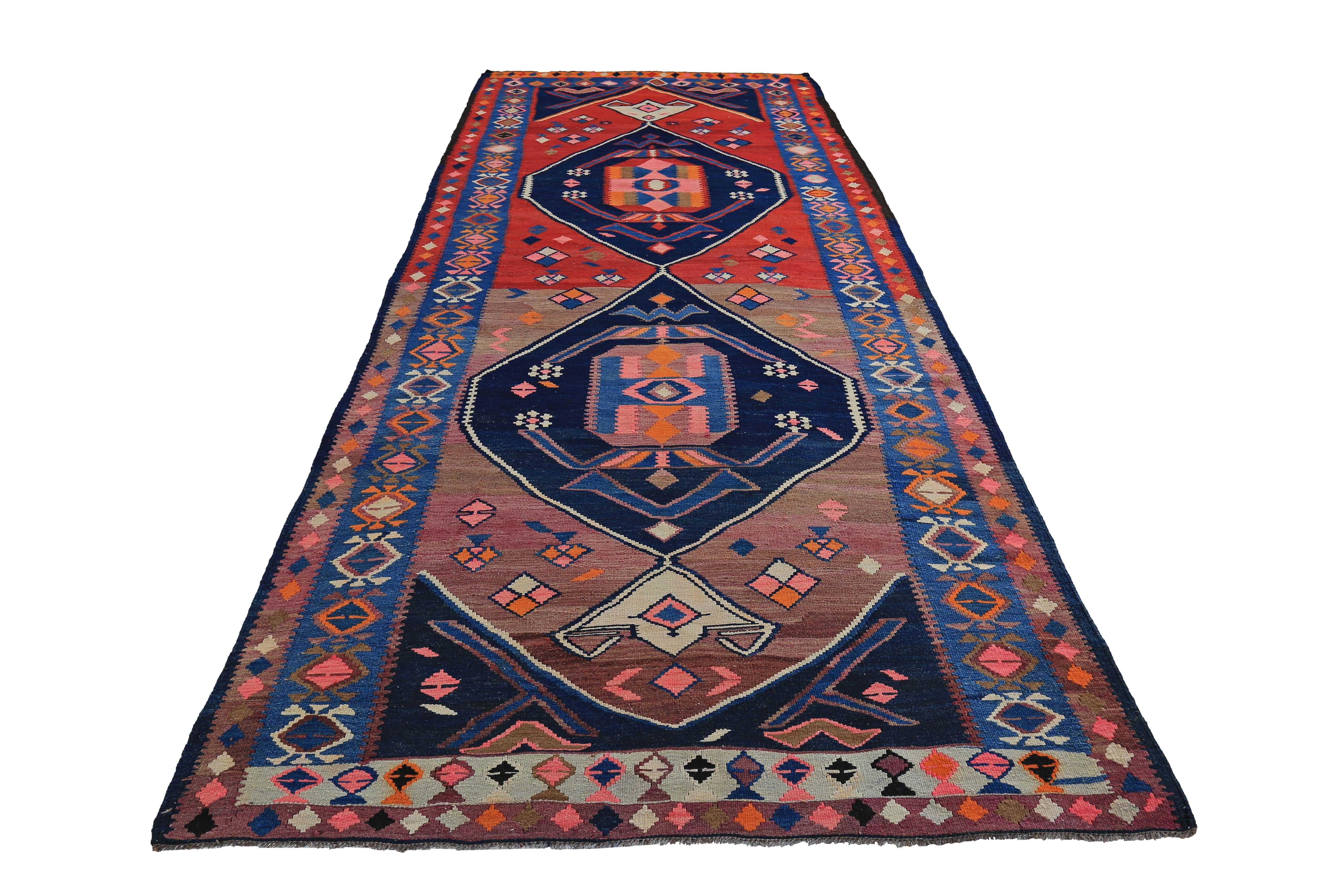 Turkish rug handwoven from the finest sheep’s wool and colored with all-natural vegetable dyes that are safe for humans and pets. It’s a traditional Kilim flat-weave design featuring blue, red and pink tribal designs. It’s a stunning piece to get