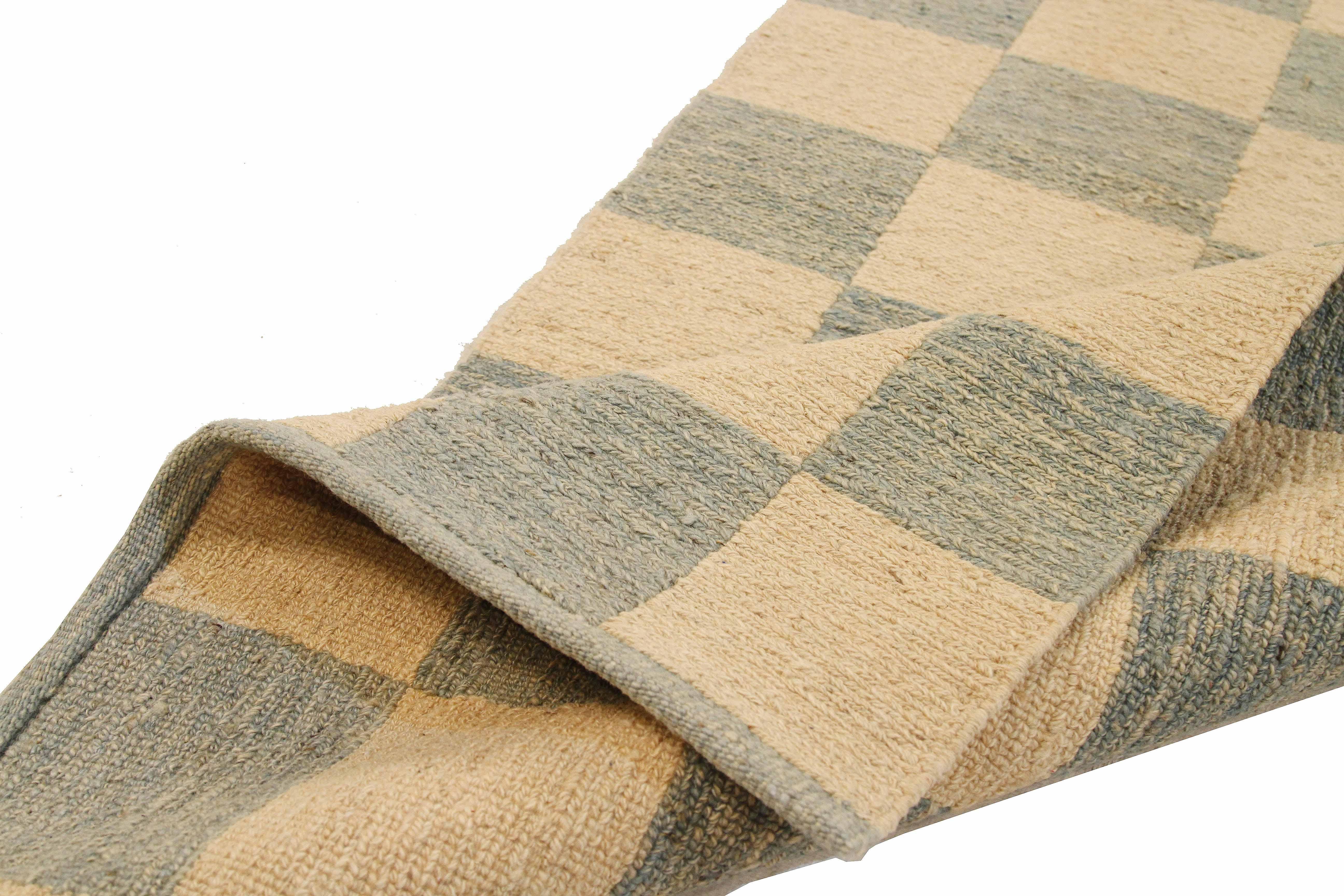 Turkish rug handwoven from the finest sheep’s wool and colored with all-natural vegetable dyes that are safe for humans and pets. It’s a traditional Kilim flat-weave design featuring green tile patterns on a plush ivory field. It’s a stunning piece