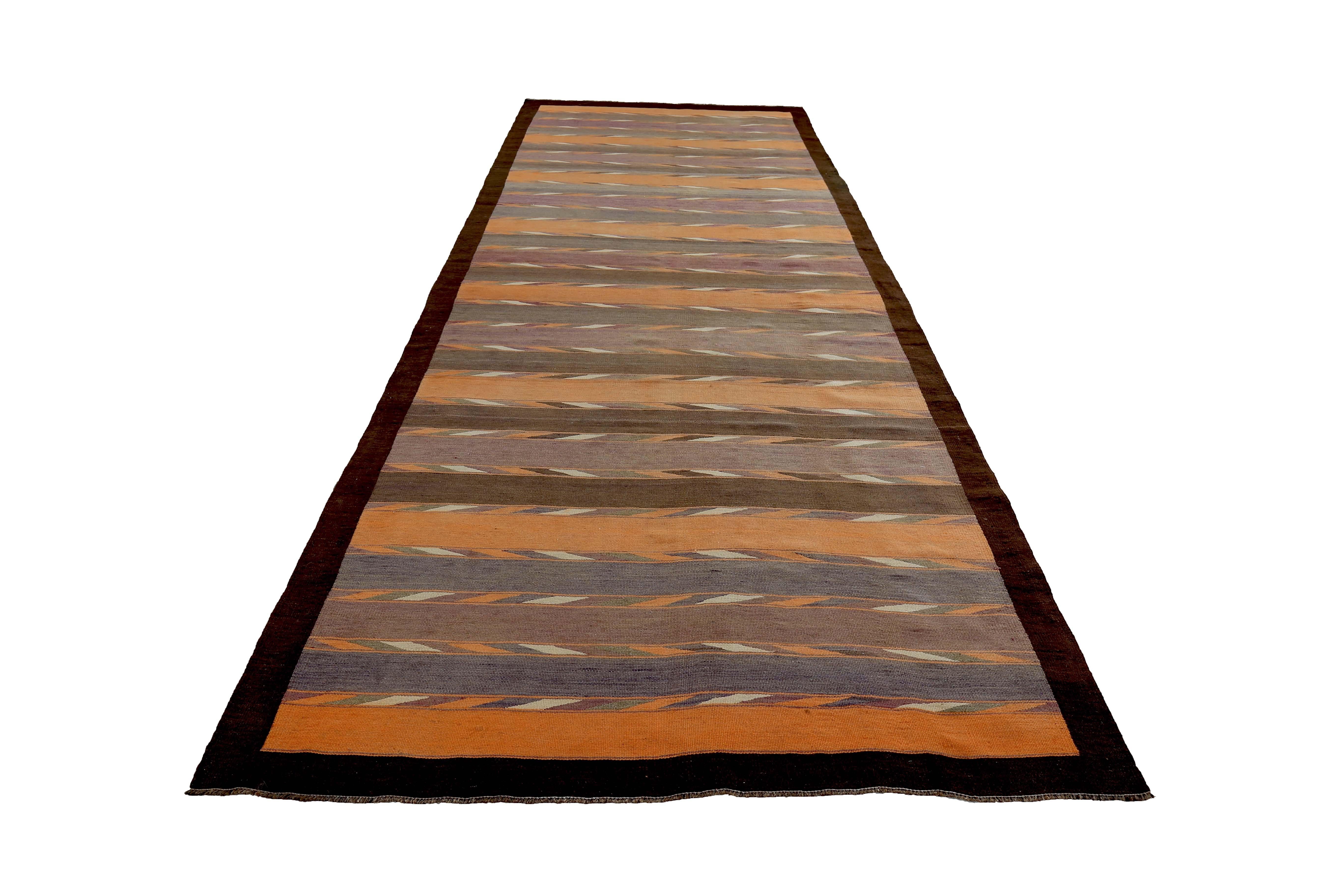 Turkish rug handwoven from the finest sheep’s wool and colored with all-natural vegetable dyes that are safe for humans and pets. It’s a traditional Kilim flat-weave design featuring orange, purple and brown tribal stripes. It’s a stunning piece to