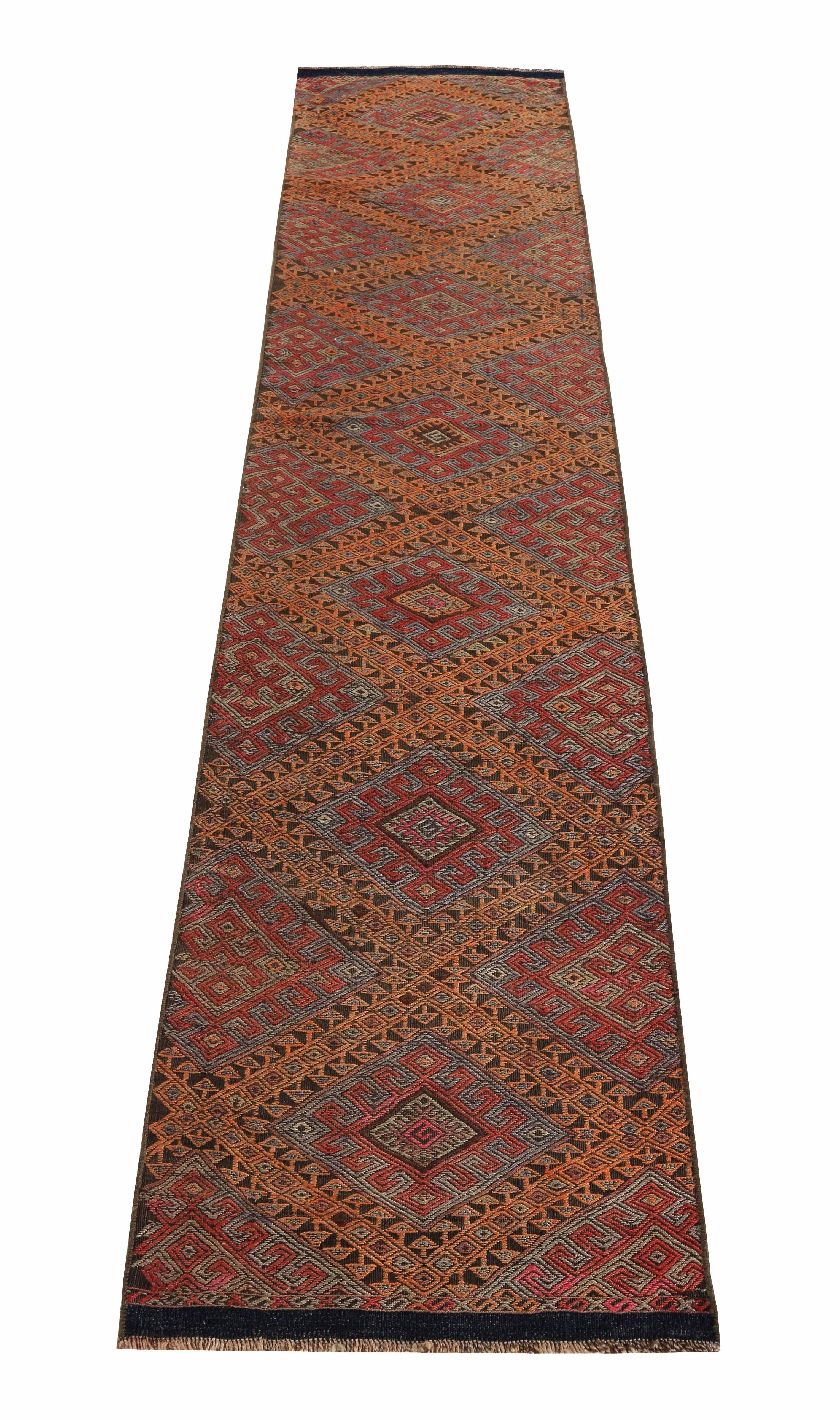 Modern Turkish rug handwoven from the finest sheep’s wool and colored with all-natural vegetable dyes that are safe for humans and pets. It’s a traditional Kilim flat-weave design featuring orange and red tribal patterns. It’s a stunning piece to