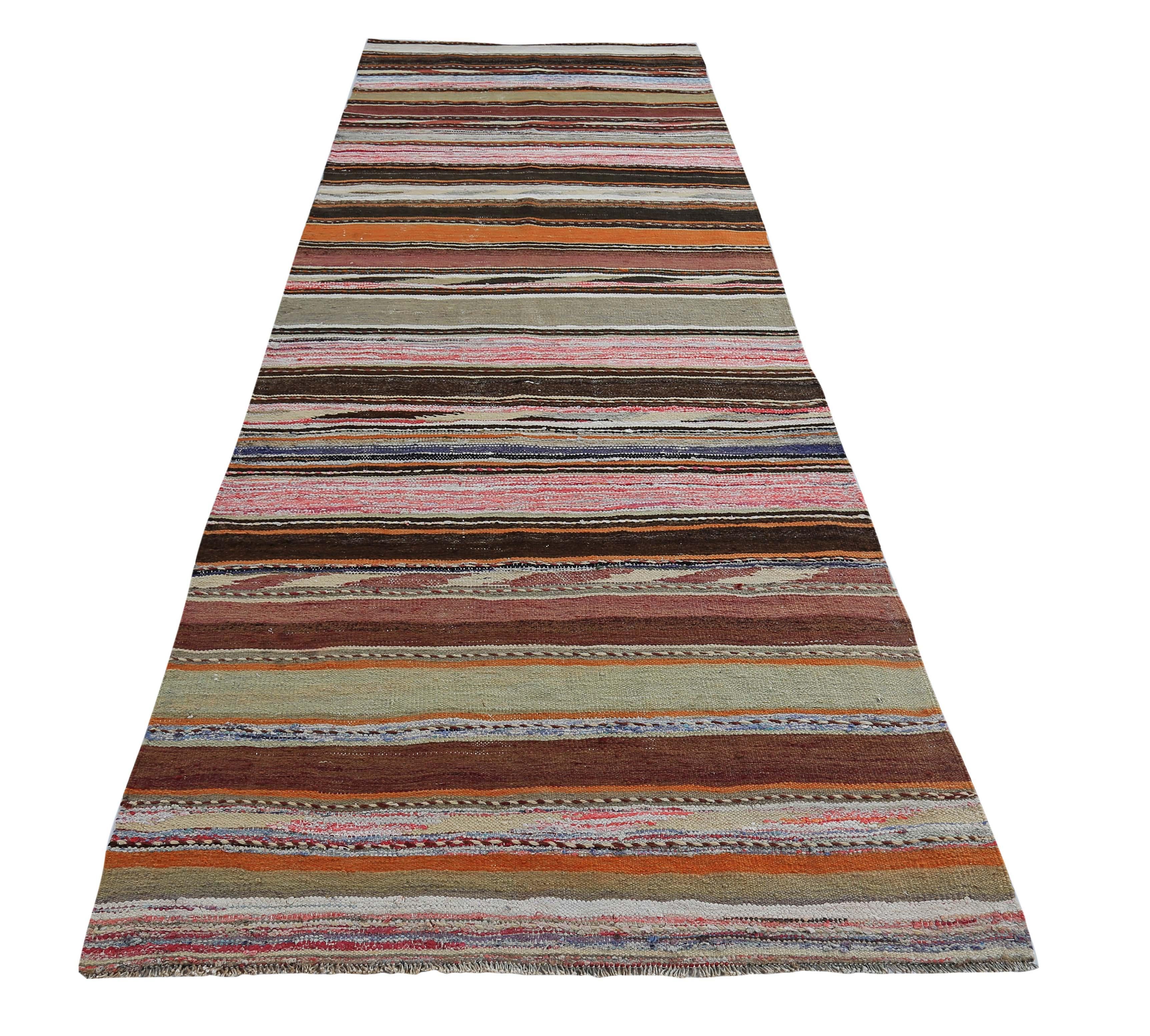 Turkish rug handwoven from the finest sheep’s wool and colored with all-natural vegetable dyes that are safe for humans and pets. It’s a traditional Kilim flat-weave design featuring pink, orange and black stripes. It’s a stunning piece to get for