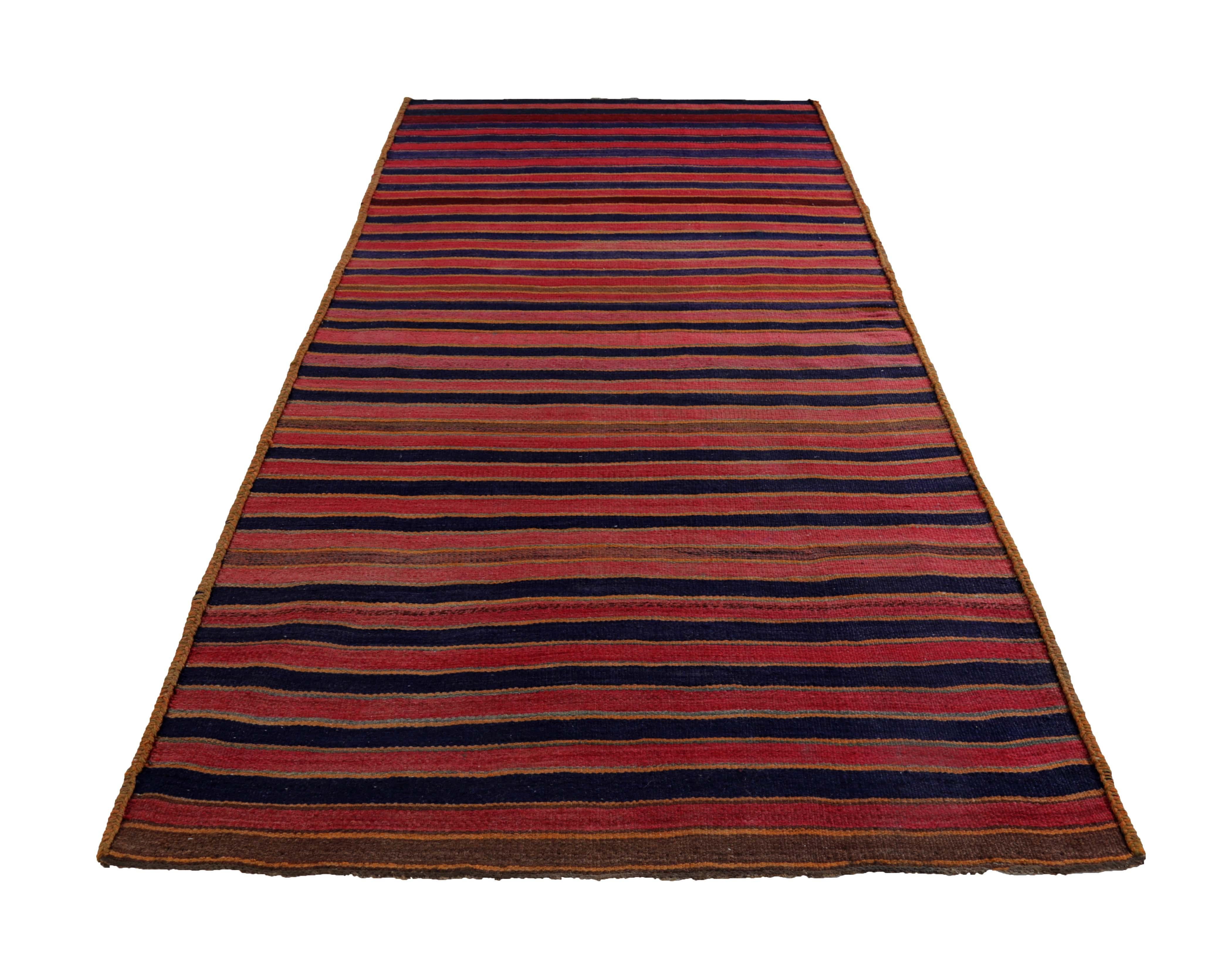Turkish rug handwoven from the finest sheep’s wool and colored with all-natural vegetable dyes that are safe for humans and pets. It’s a traditional Kilim flat-weave design featuring red and blue stripes on a brown field. It’s a stunning piece to