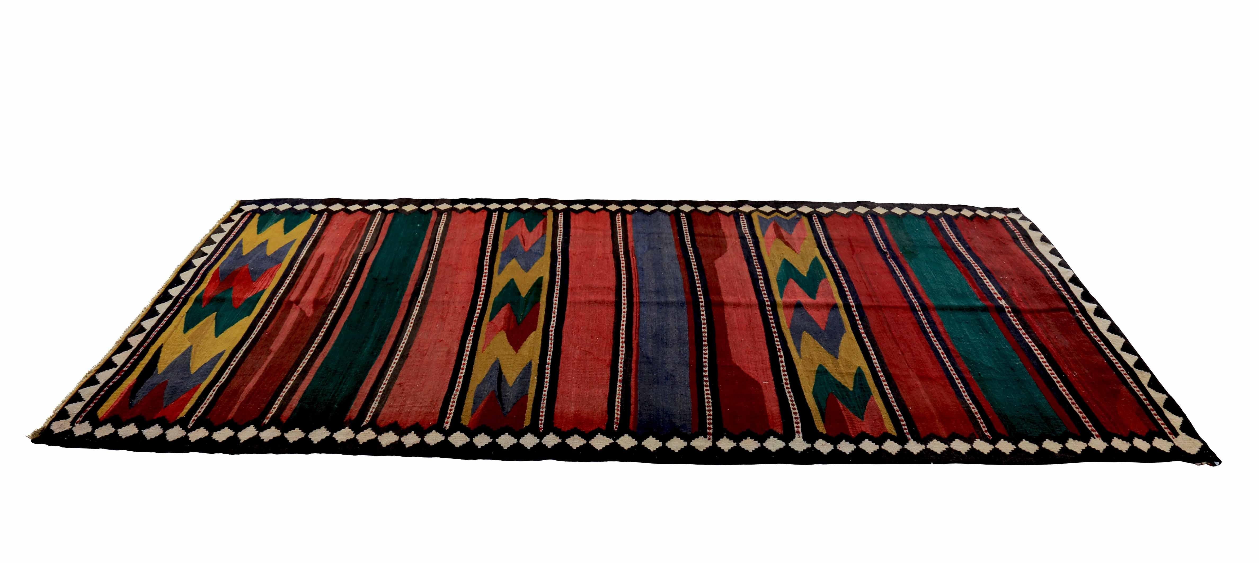 Modern Turkish rug handwoven from the finest sheep’s wool and colored with all-natural vegetable dyes that are safe for humans and pets. It’s a traditional Kilim flat-weave design featuring green and red tribal patterns. It’s a stunning piece to get