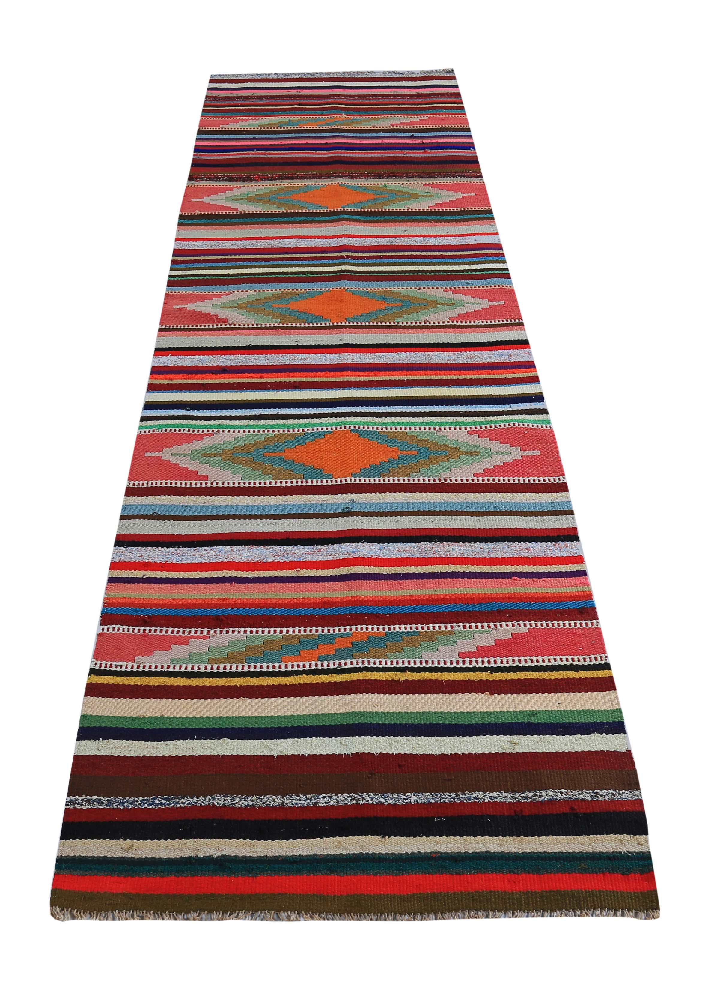 Turkish rug handwoven from the finest sheep’s wool and colored with all-natural vegetable dyes that are safe for humans and pets. It’s a traditional Kilim flat-weave design featuring red, orange and black stripes. It’s a stunning piece to get for