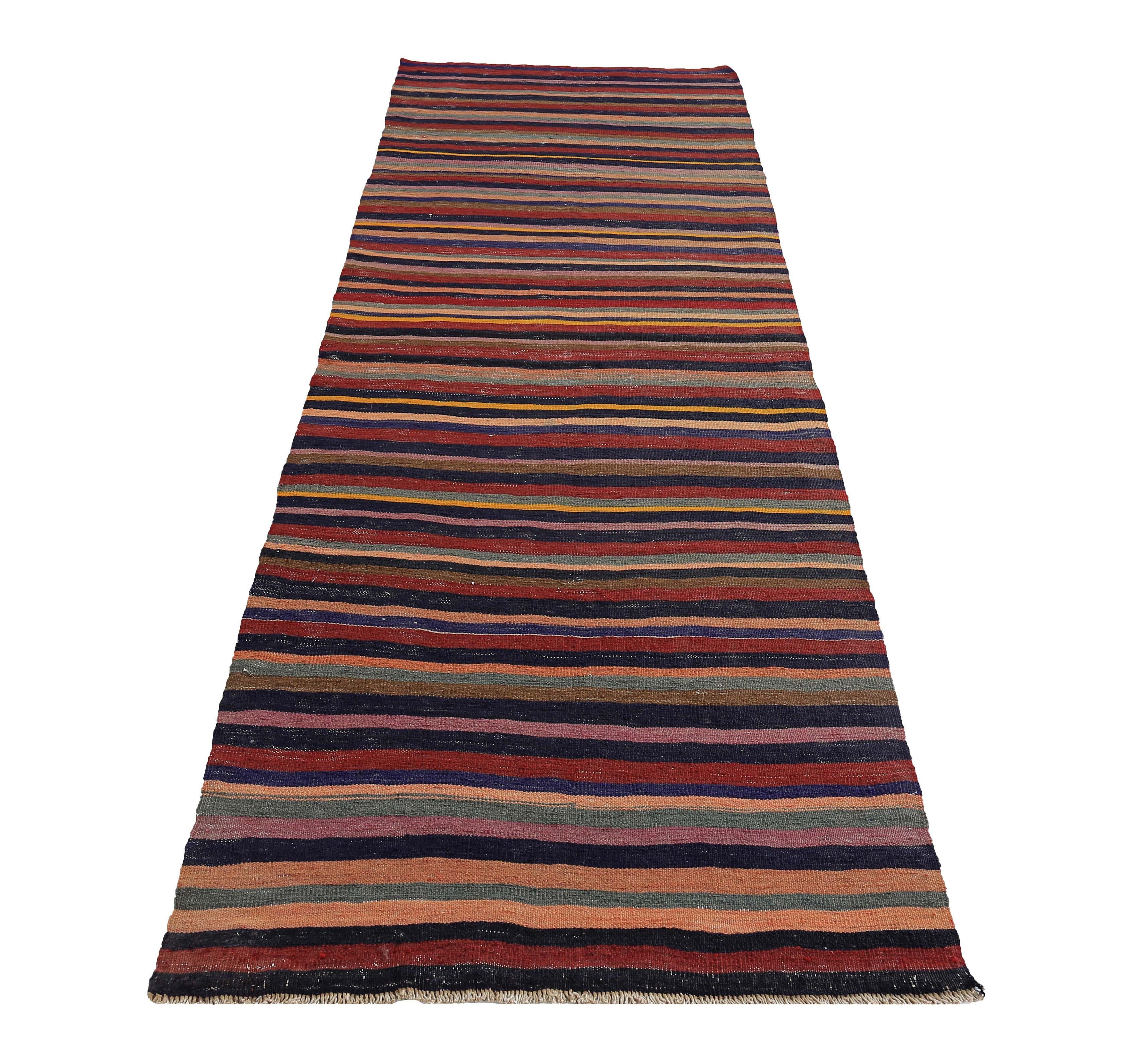 Turkish rug handwoven from the finest sheep’s wool and colored with all-natural vegetable dyes that are safe for humans and pets. It’s a traditional Kilim flat-weave design featuring red, orange and blue stripes. It’s a stunning piece to get for
