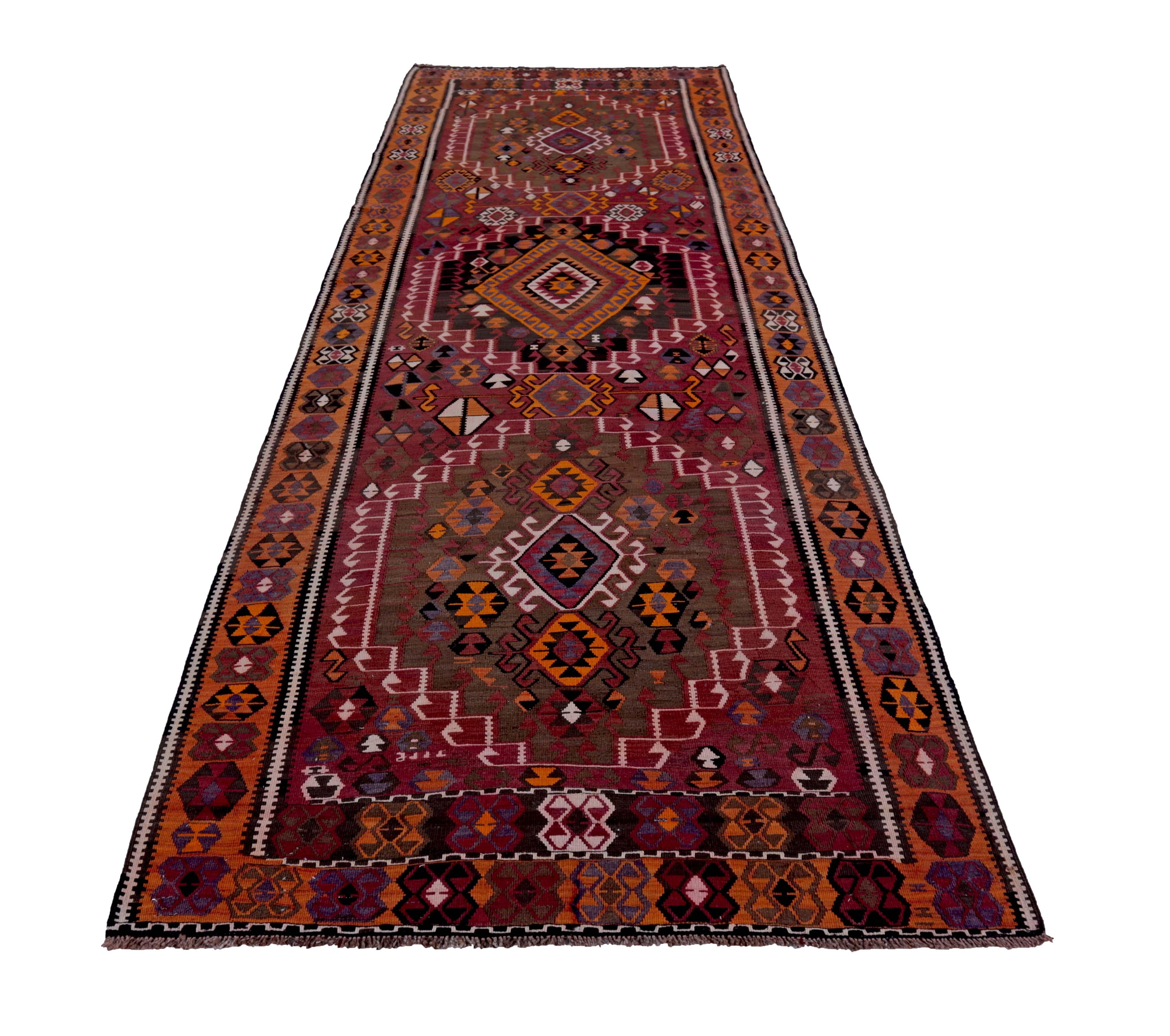 Turkish rug handwoven from the finest sheep’s wool and colored with all-natural vegetable dyes that are safe for humans and pets. It’s a traditional Kilim flat-weave design featuring red, orange and brown tribal designs. It’s a stunning piece to get