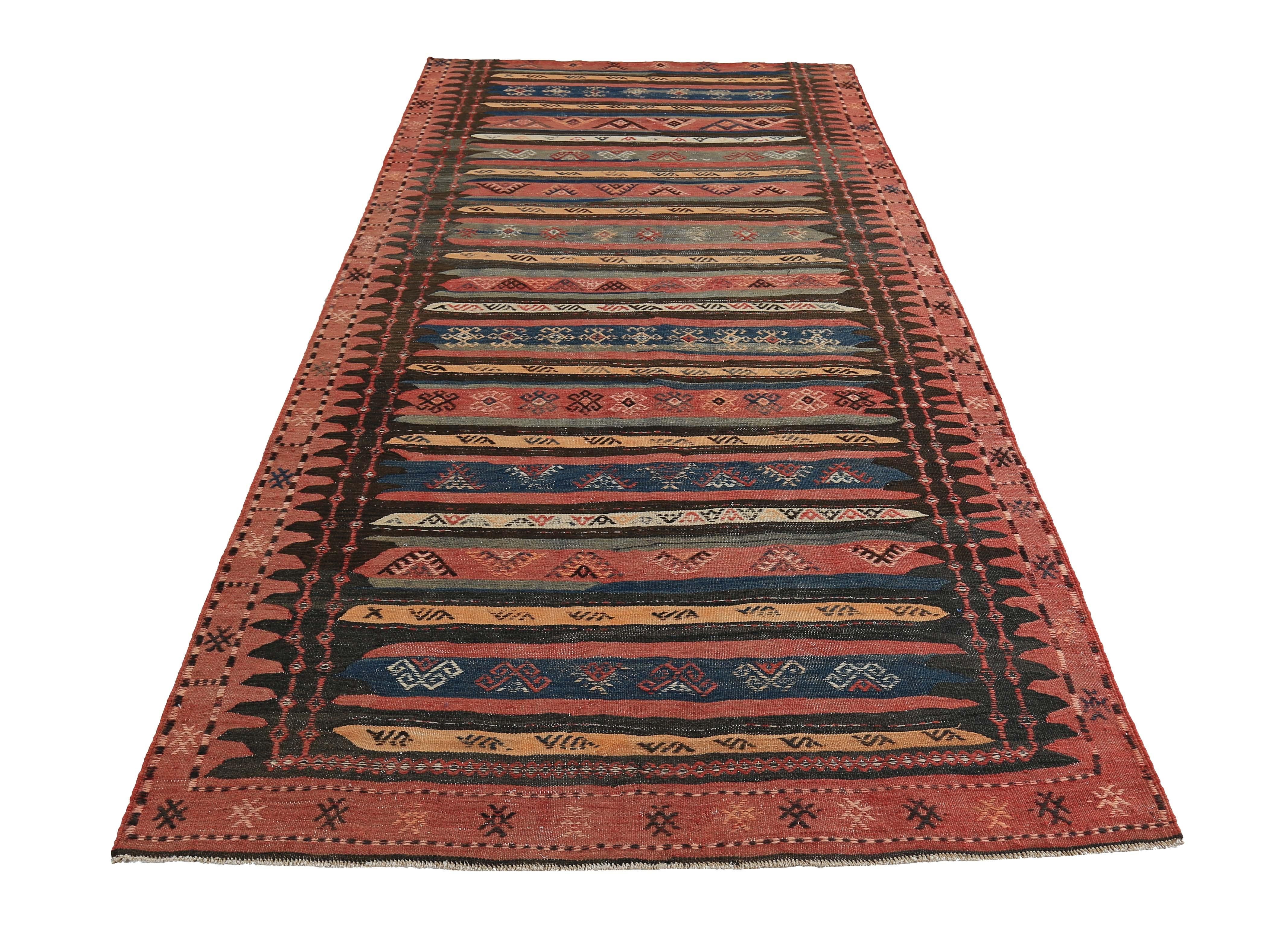 Turkish rug handwoven from the finest sheep’s wool and colored with all-natural vegetable dyes that are safe for humans and pets. It’s a traditional Kilim flat-weave design featuring red, orange and brown tribal stripes. It’s a stunning piece to get