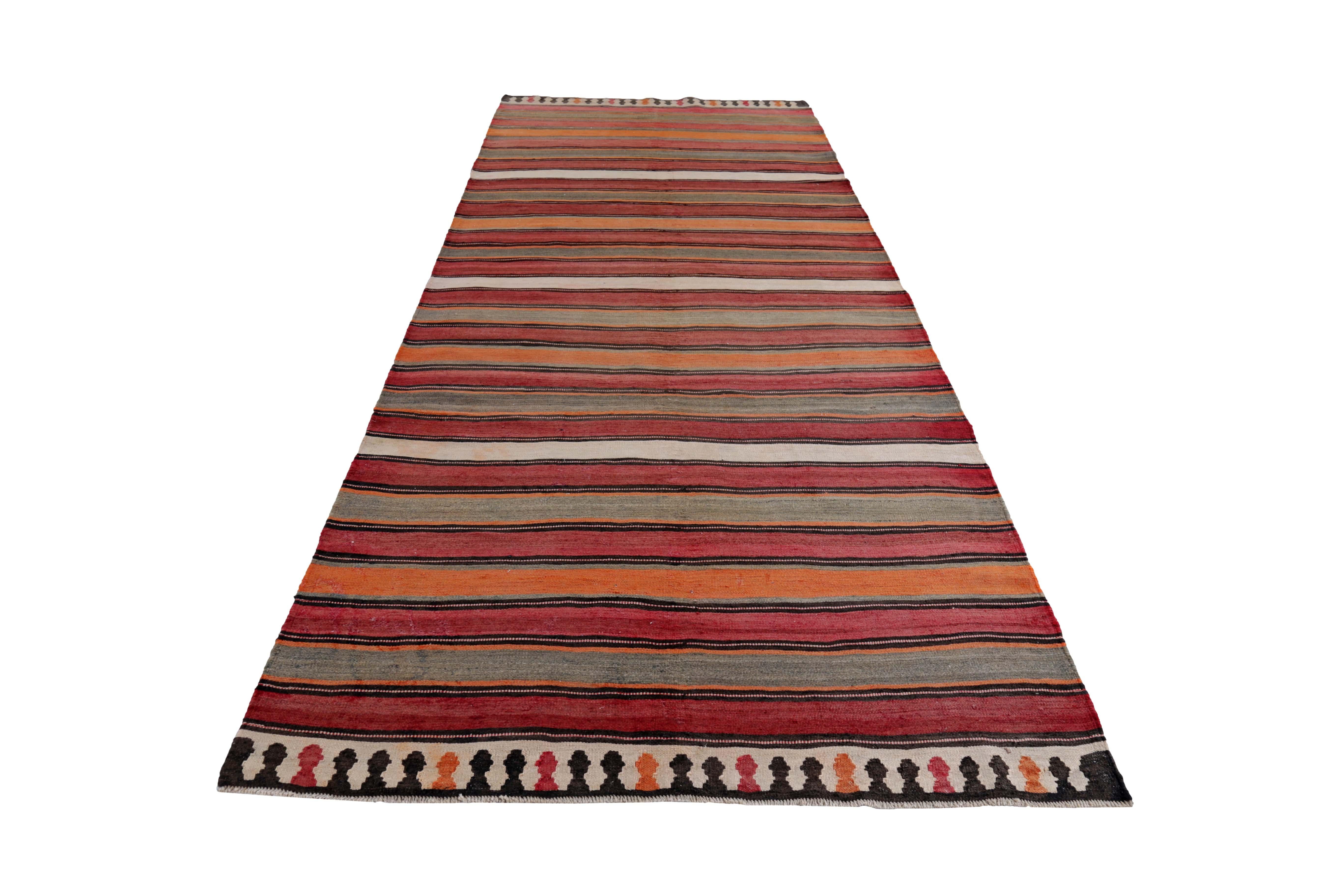 Turkish rug handwoven from the finest sheep’s wool and colored with all-natural vegetable dyes that are safe for humans and pets. It’s a traditional Kilim flat-weave design featuring red, orange and ivory stripes pattern. It’s a stunning piece to