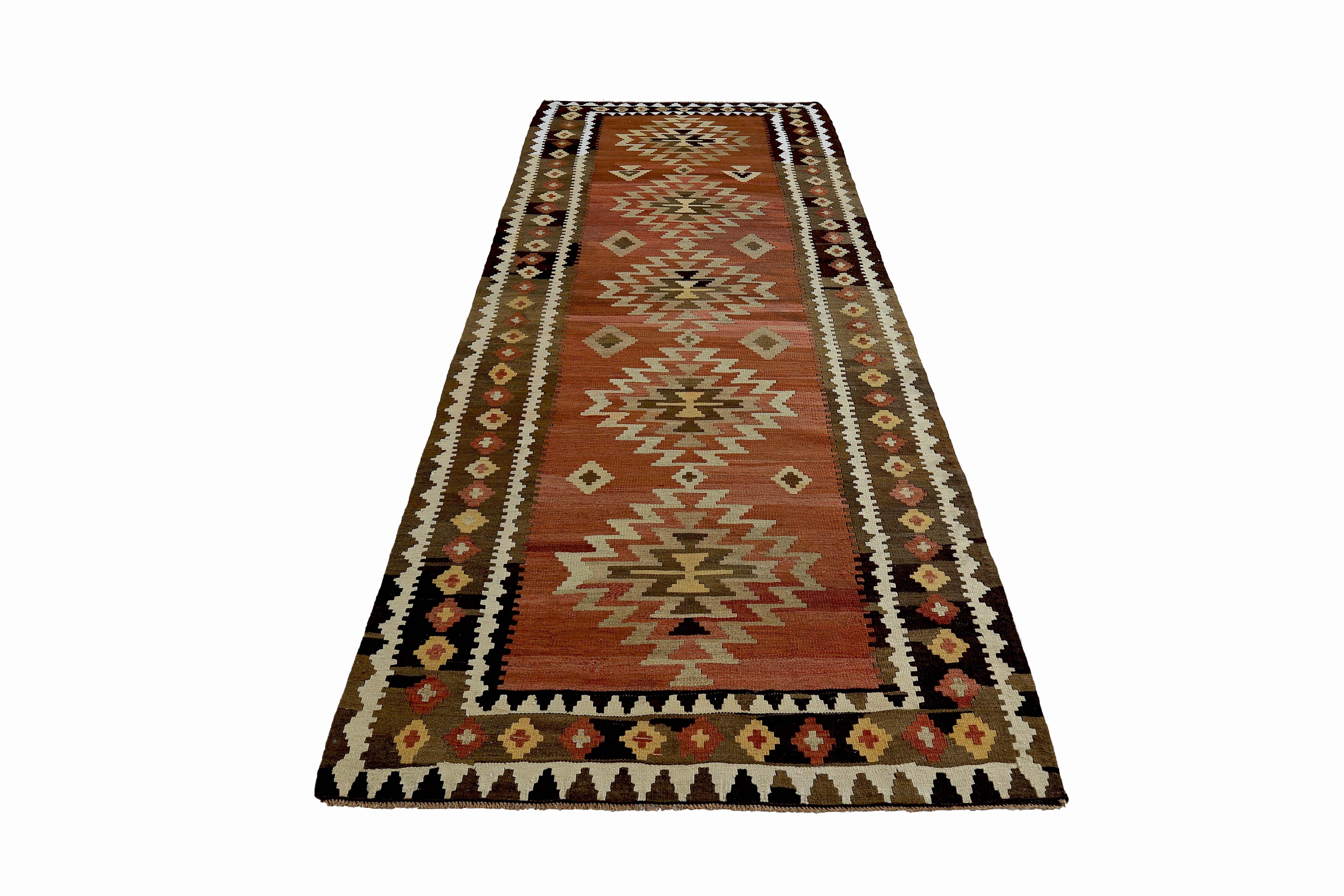 Turkish rug handwoven from the finest sheep’s wool and colored with all-natural vegetable dyes that are safe for humans and pets. It’s a traditional Kilim flat-weave design featuring white, brown and beige tribal patterns. It’s a stunning piece to