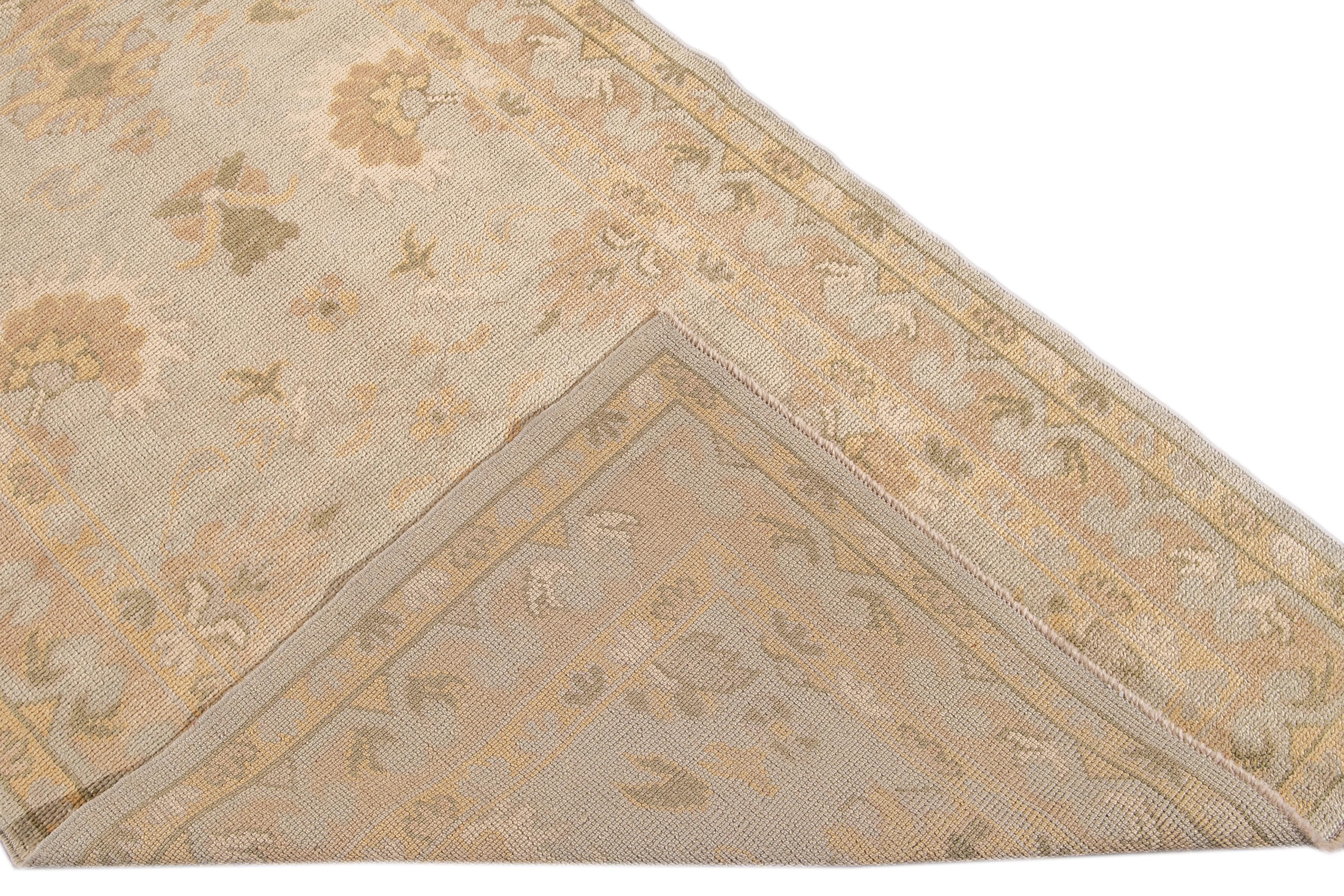 Beautiful Modern Turkish Oushak hand-knotted scatter wool rug with a gray field. This Oushak has accents and a frame of yellow, tan, and green in an all-over geometric floral design.

This Rug measures: 3'9