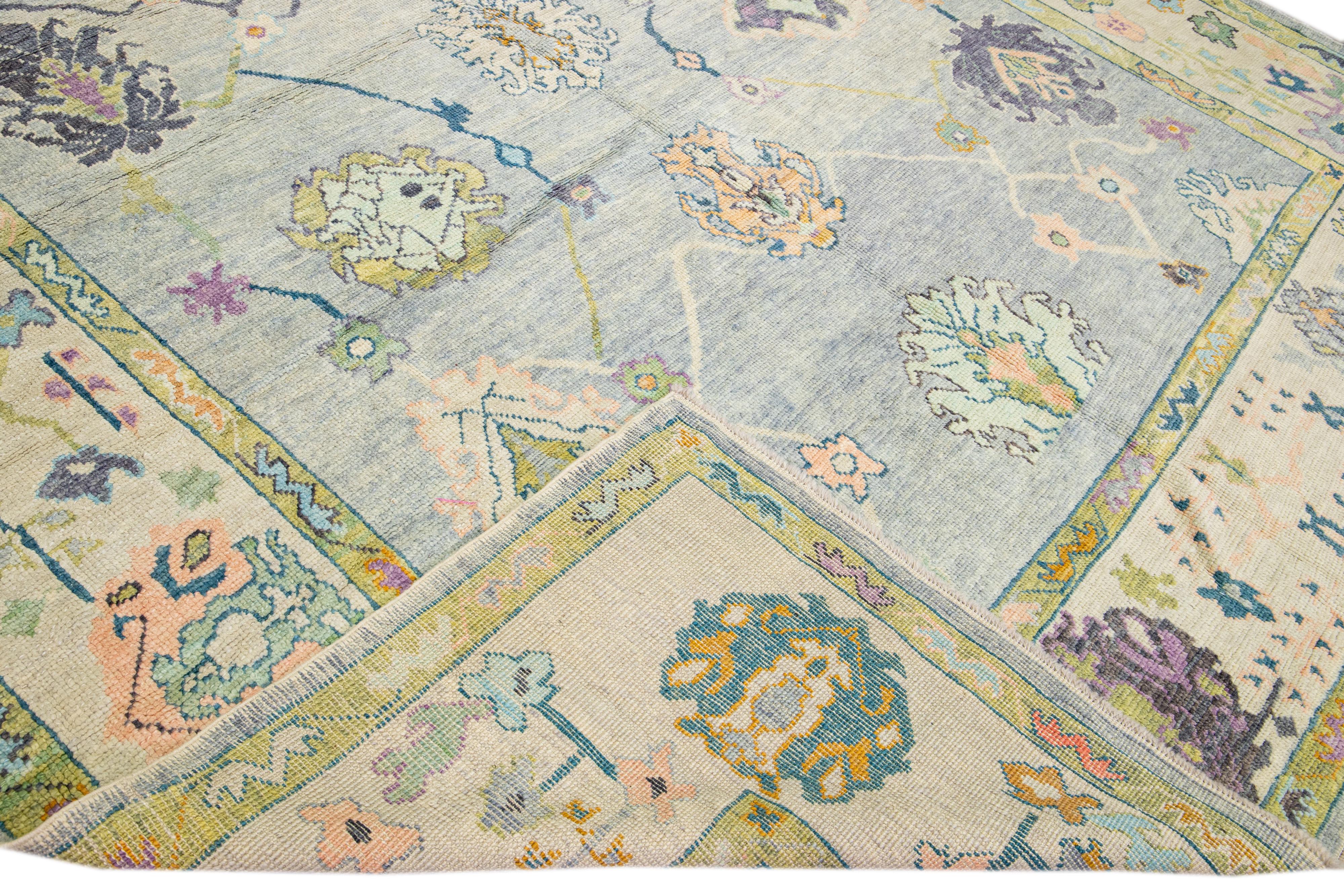 Beautiful modern Oushak hand-knotted wool rug with a gray field. This Oushak rug has beige and yellow frame multicolor accents that feature a gorgeous geometric floral pattern design. 

This rug measures: 9'8